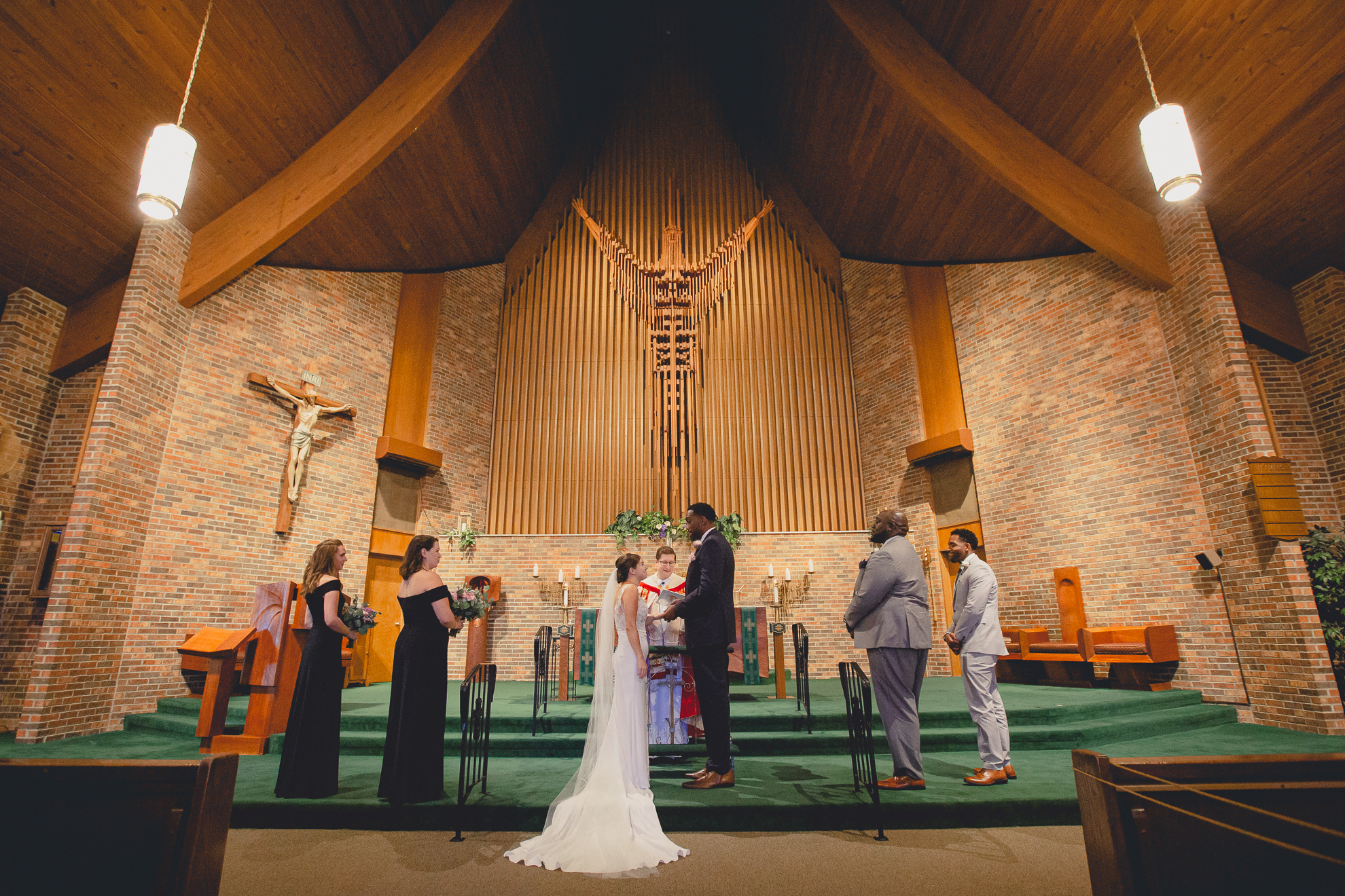 bride and groom say vows during micro wedding ceremony at St. Peter's Church in Lewiston, NY
