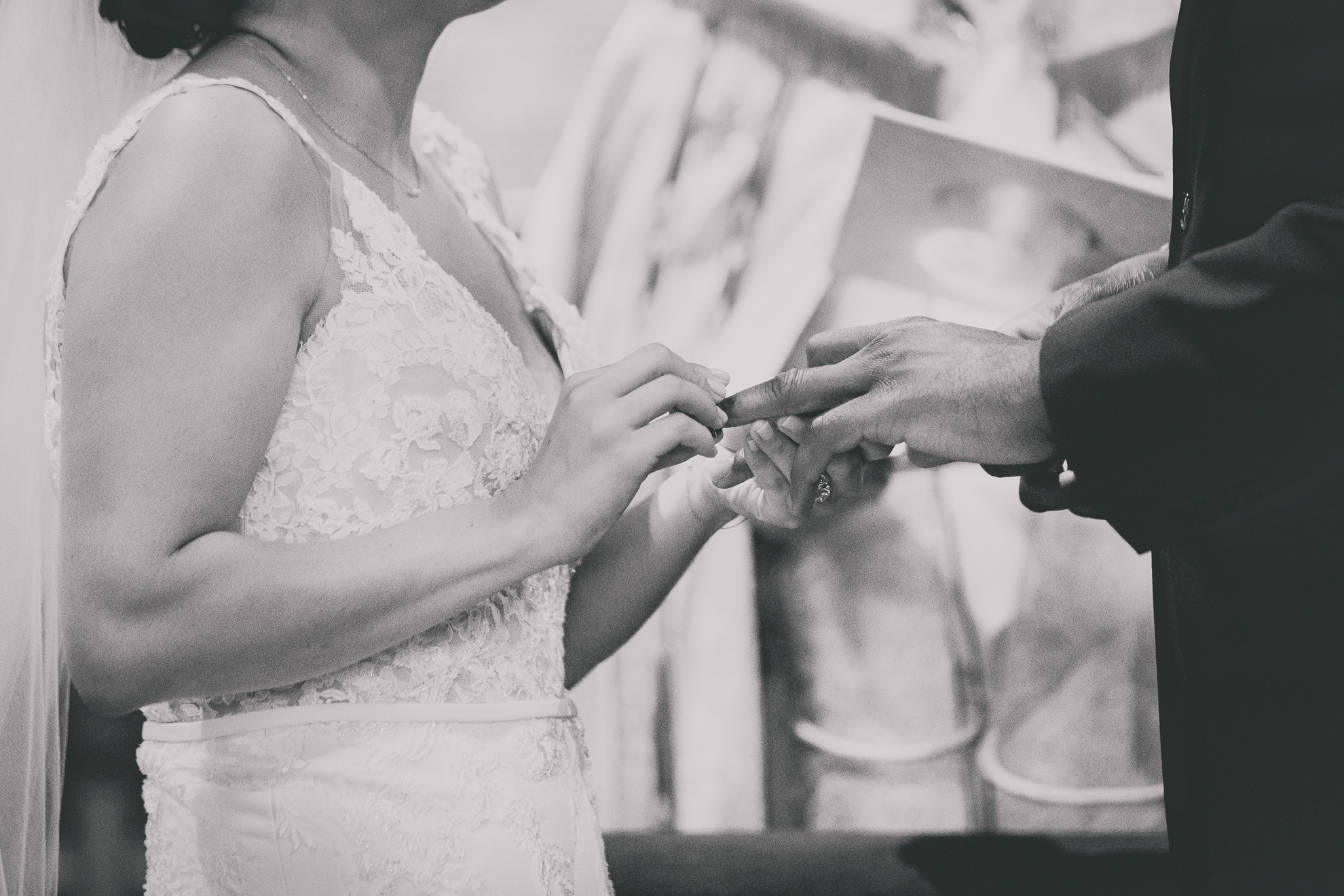 bride and groom exchange rings during micro wedding ceremony at St. Peter's Church in Lewiston, NY