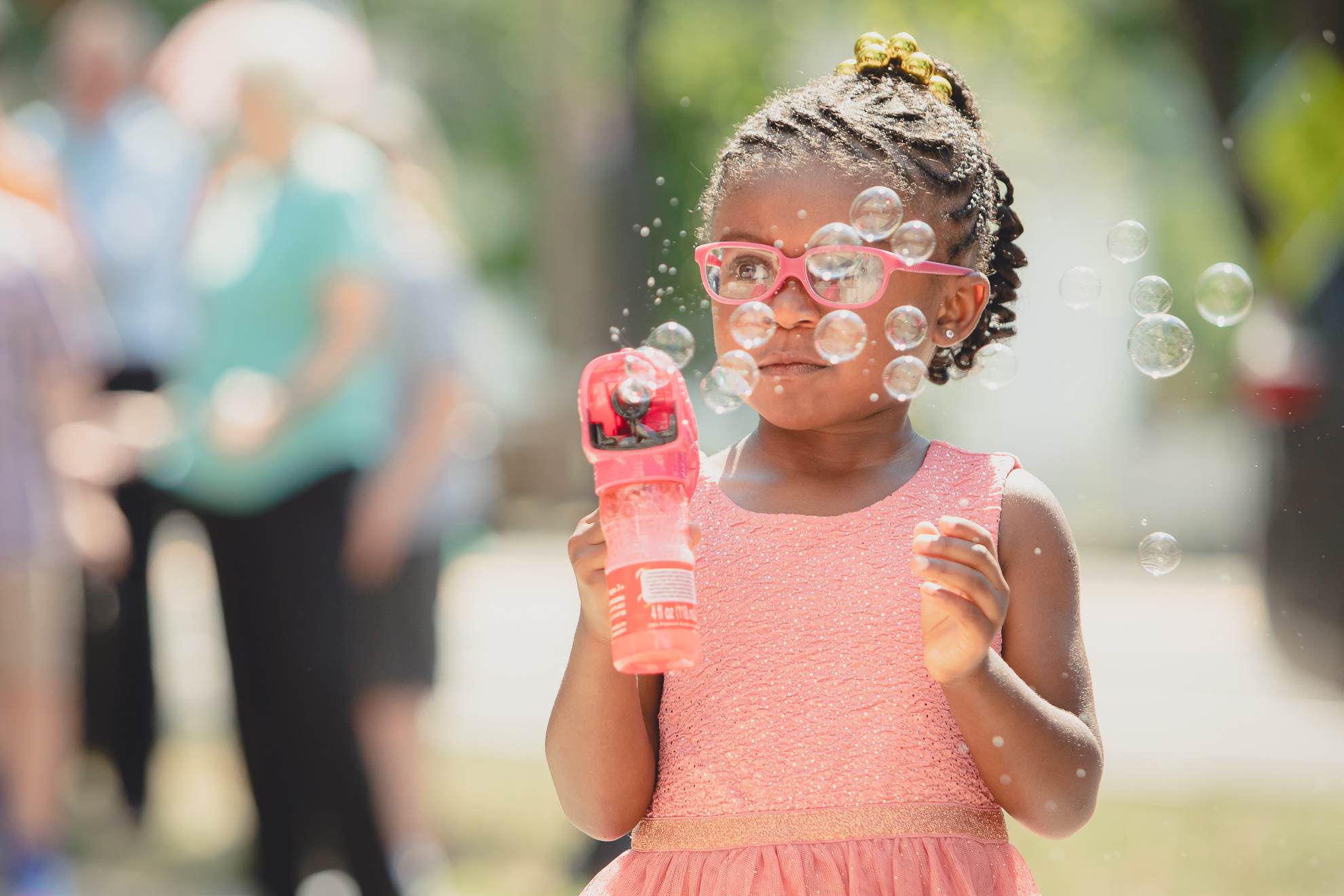 little girl blows bubbles from bubble gun during micro wedding ceremony at St. Peter's Church in Lewiston, NY
