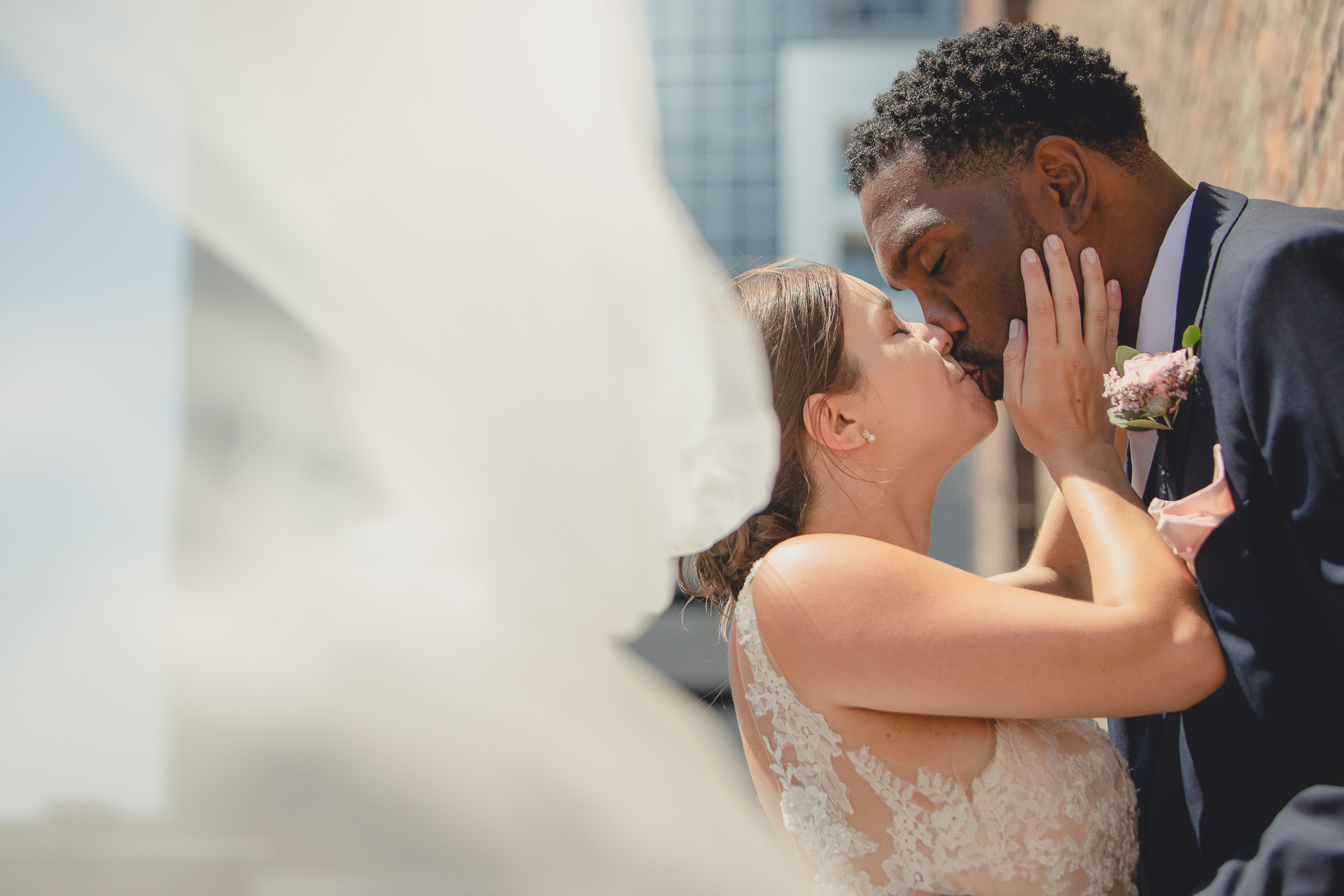 bride and groom kiss in theater district of Buffalo, NY near Shea's Theater during WNY micro wedding celebration