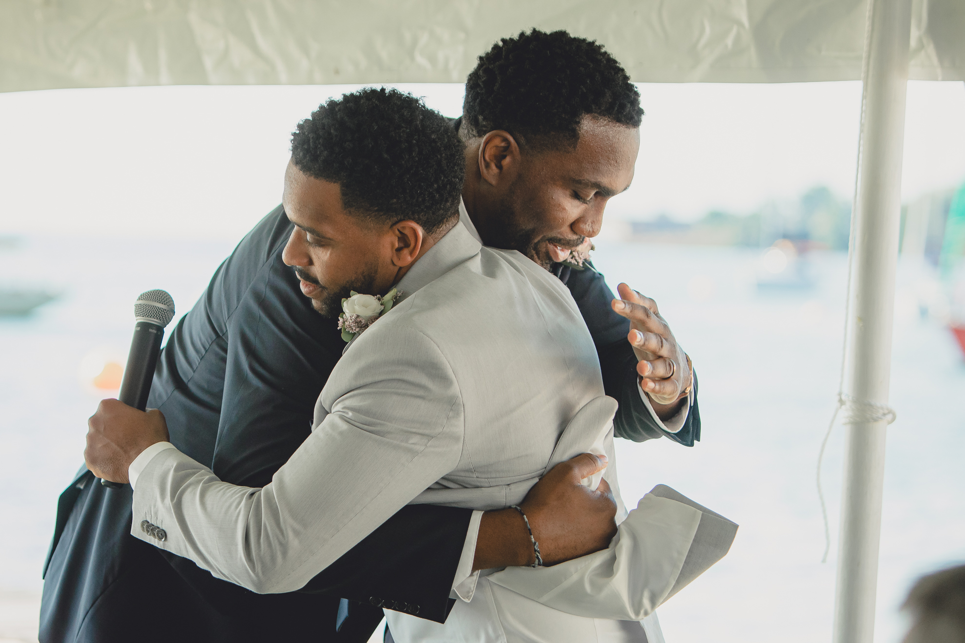 groom and best man hug after speech at Youngstown Yacht Club during WNY micro wedding