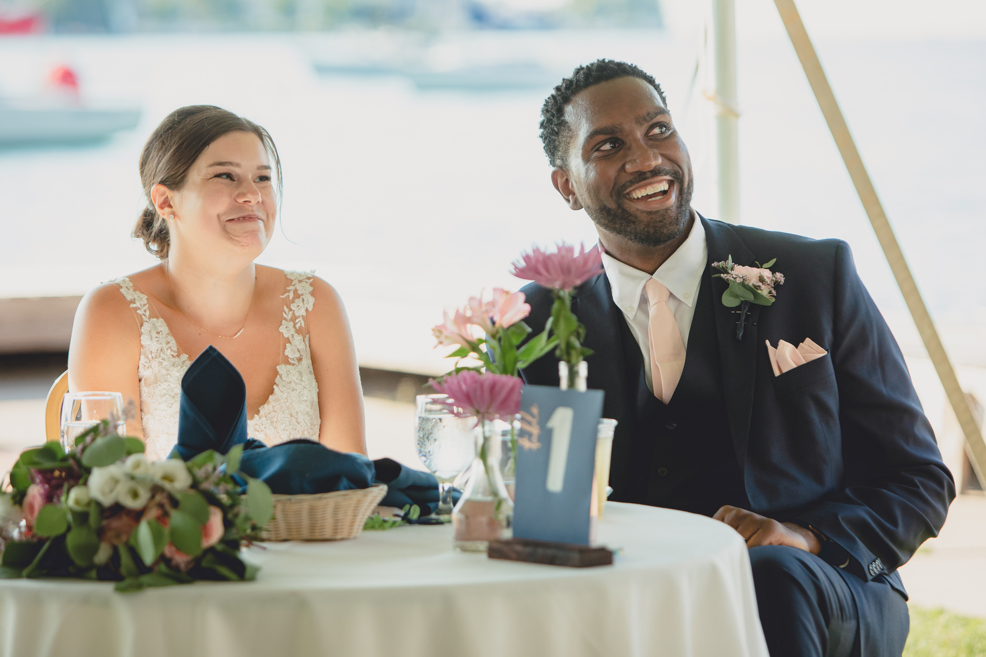bride and groom laugh during speech at Youngstown Yacht Club during WNY micro wedding