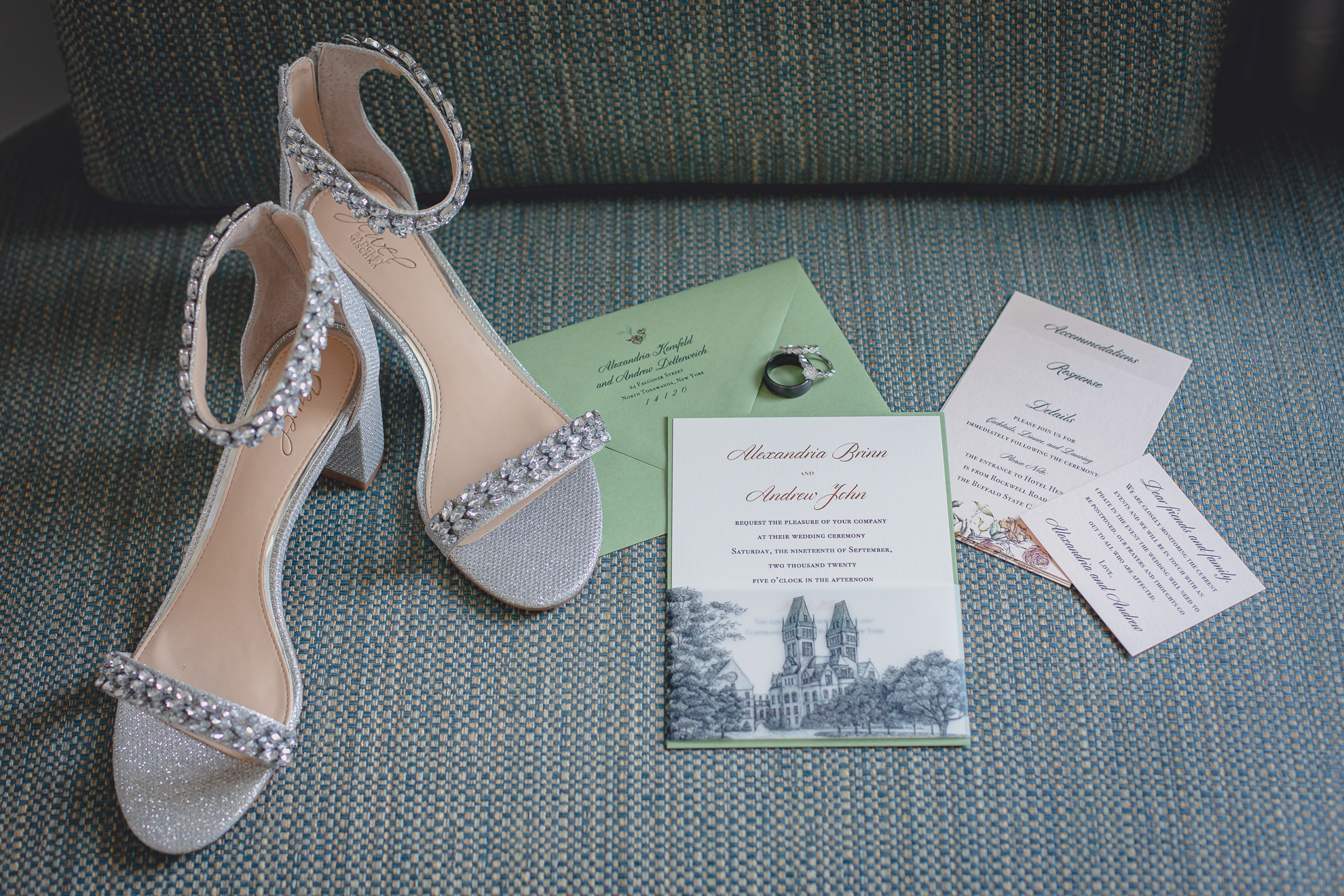 wedding invitation and other details sit on chair before wedding at Hotel Henry in Buffalo, NY