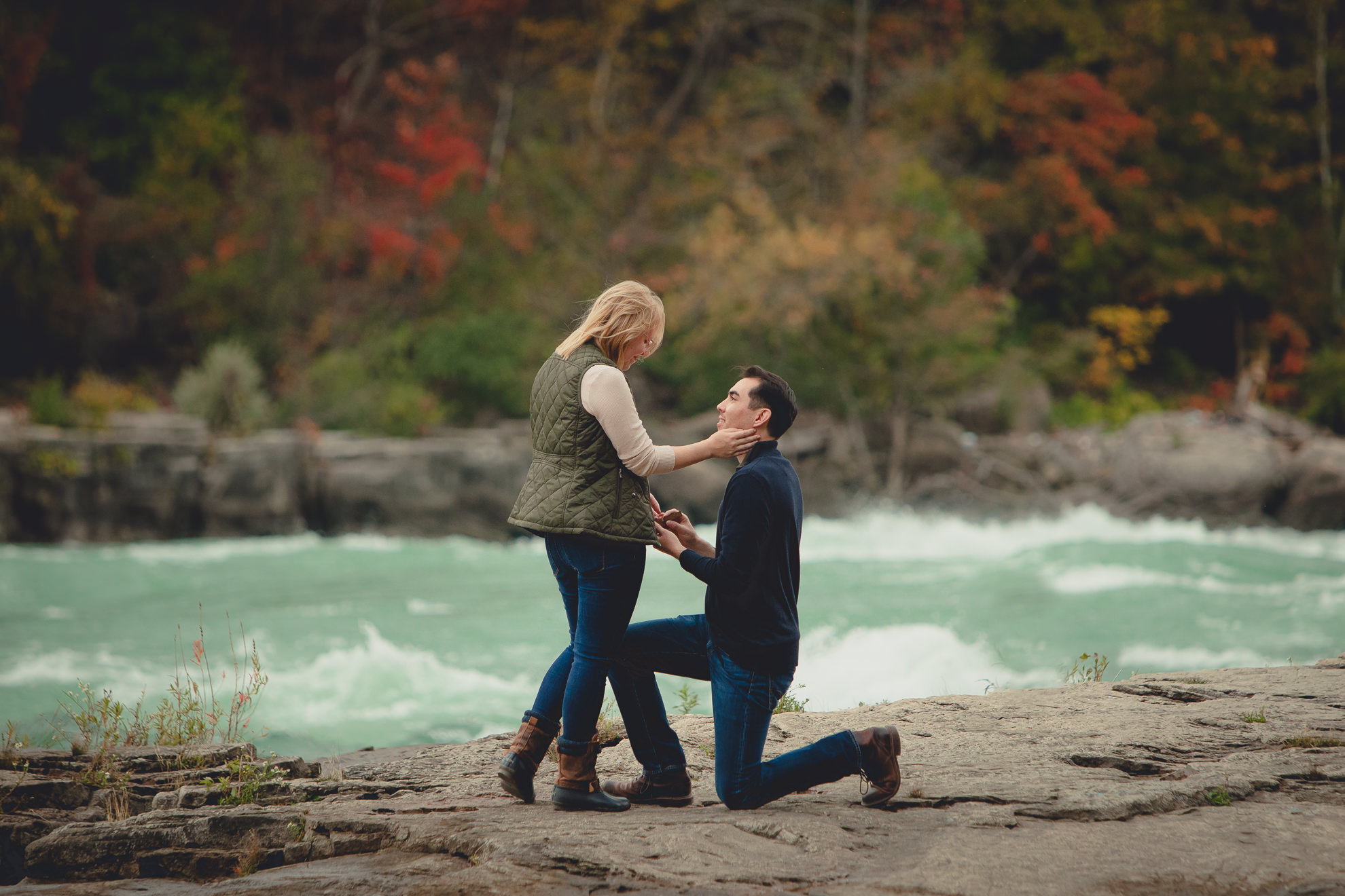 wedding engagement proposal photography with rapids and fall foliage in background at Whirlpool State Park in Niagara Falls, NY