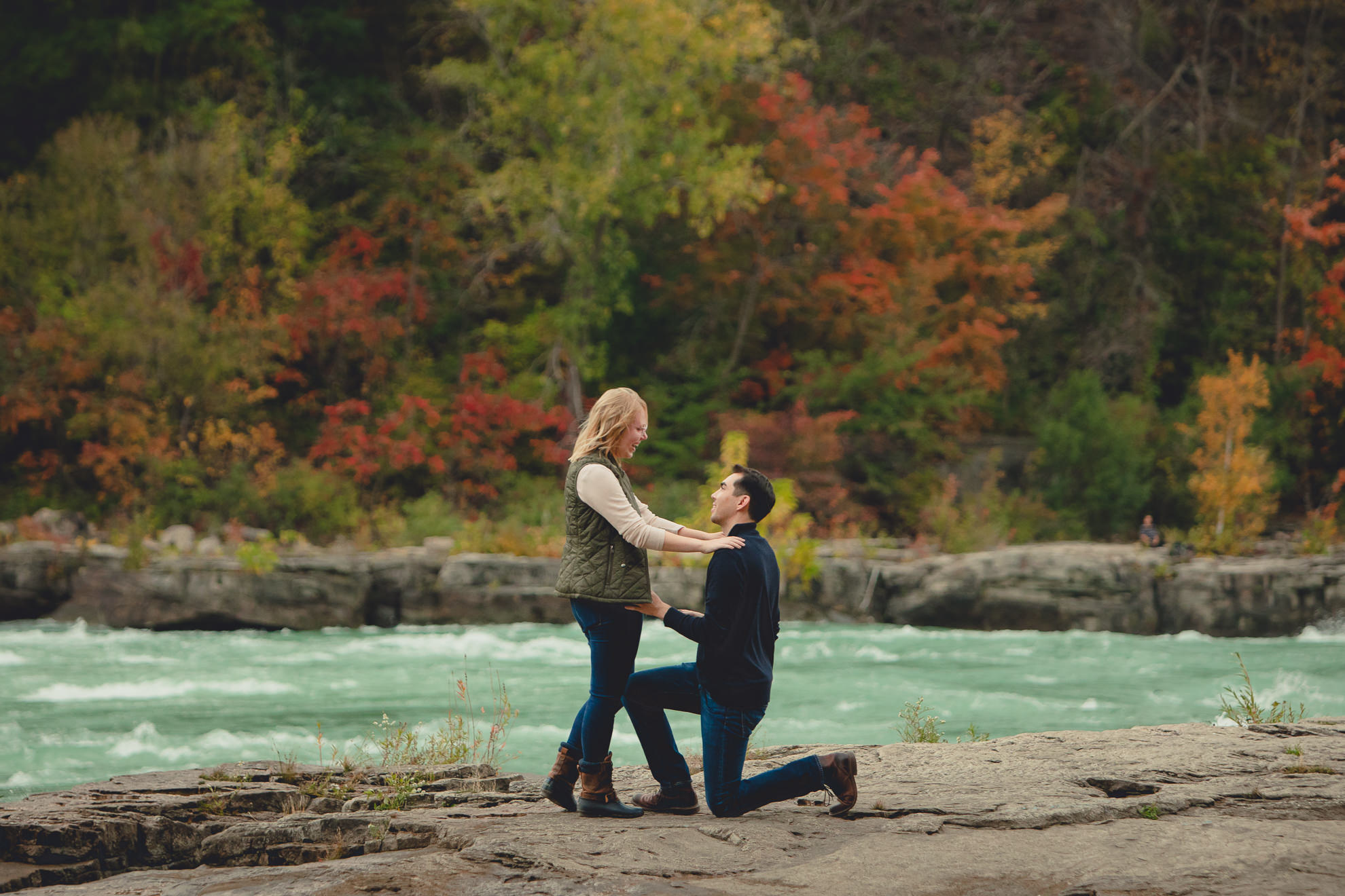 wedding engagement proposal photography with rapids and fall foliage in background at Whirlpool State Park in Niagara Falls, NY