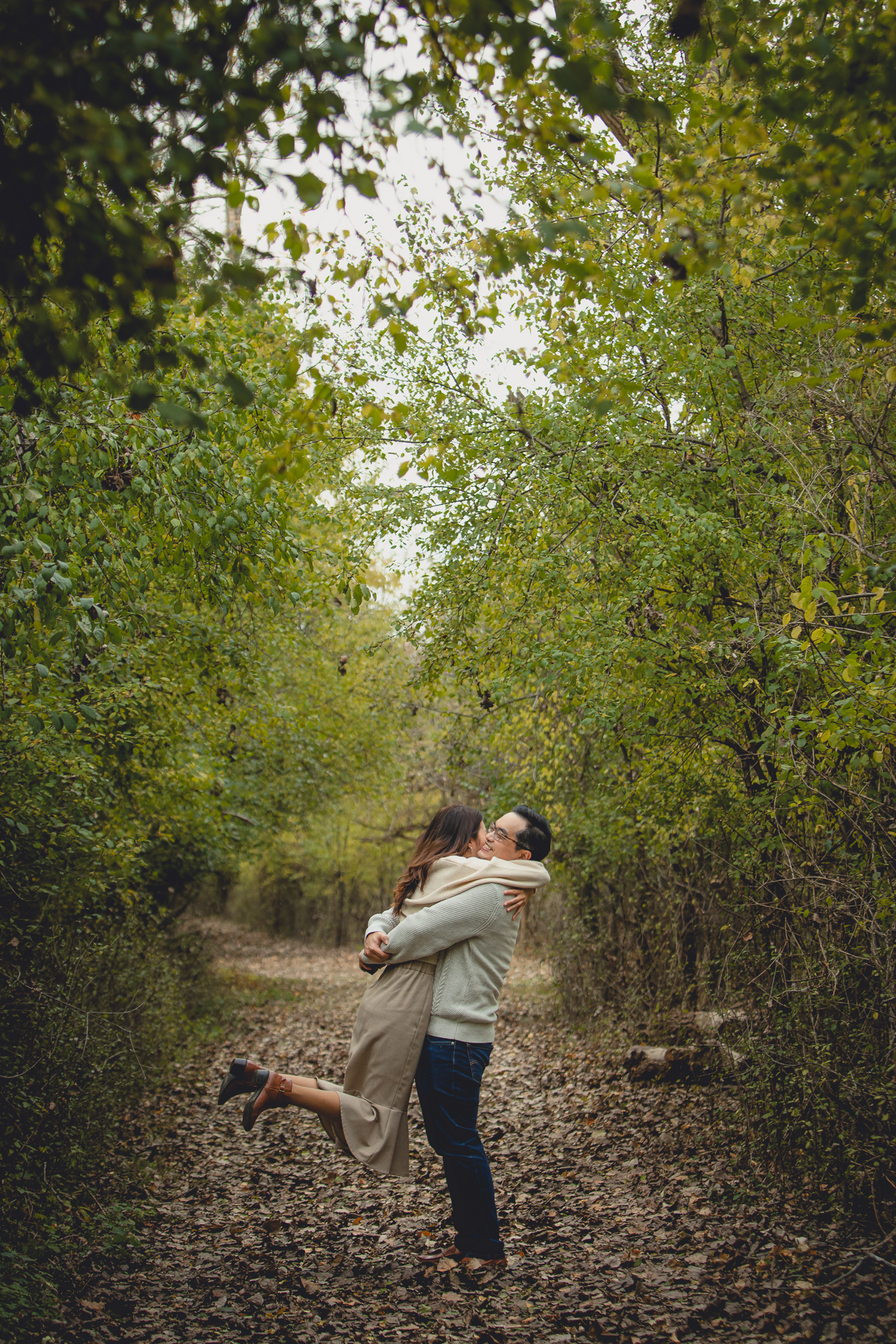 man picks up woman and spins her during wedding engagement proposal at Tifft Nature Preserve in Buffalo, NY