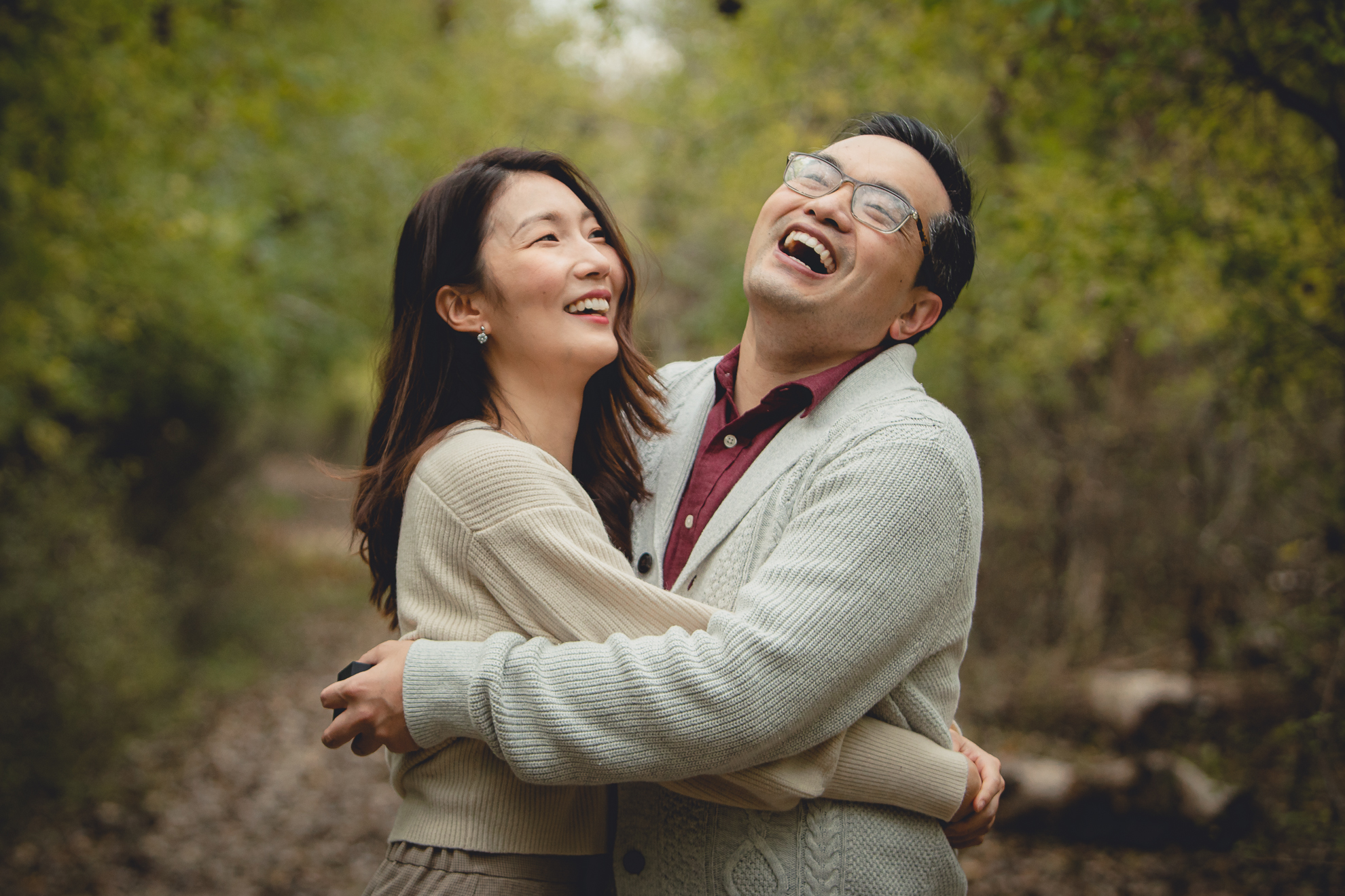man and woman laugh during wedding engagement proposal at Tifft Nature Preserve in Buffalo, NY