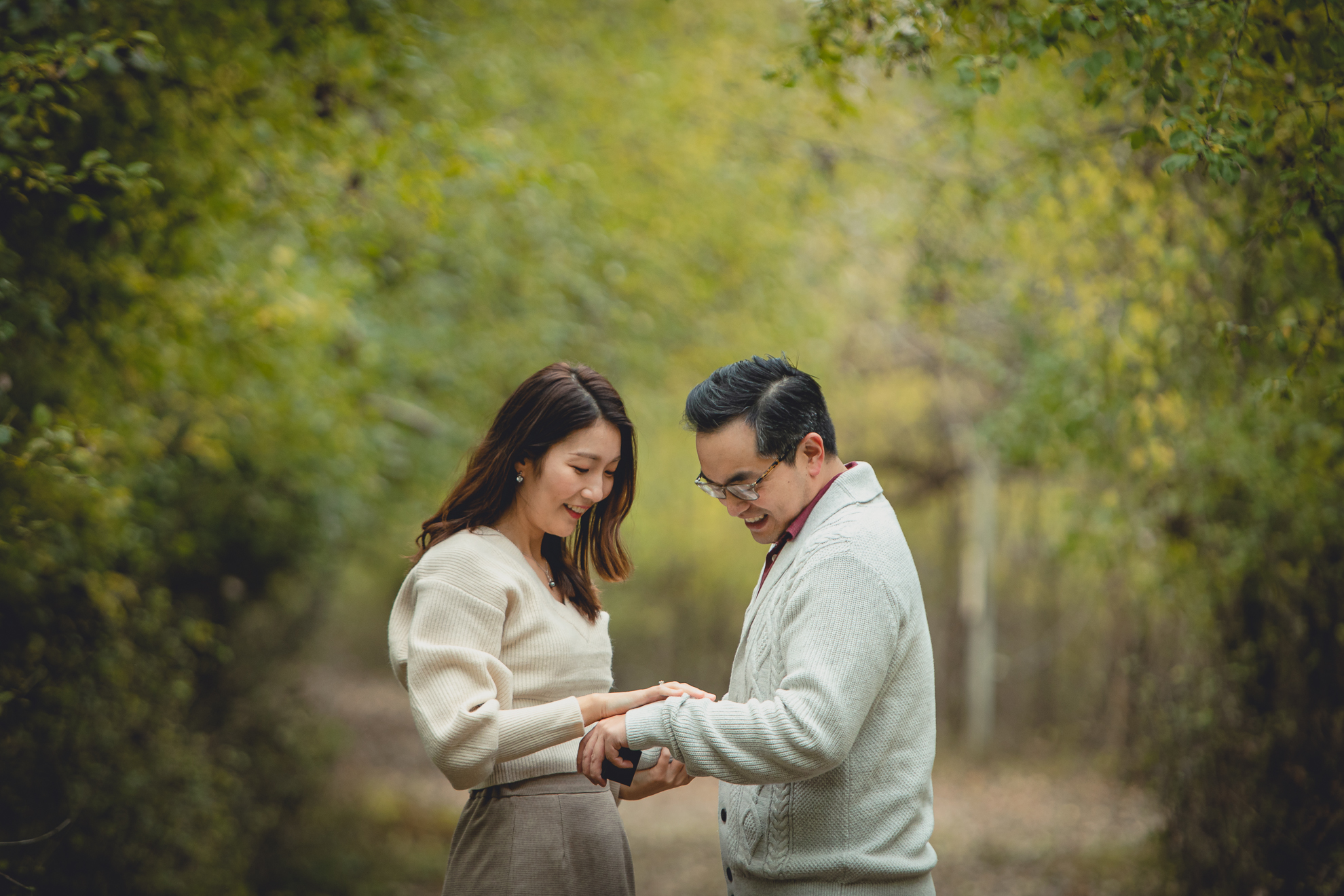 bride checks out ring during wedding engagement proposal at Tifft Nature Preserve in Buffalo, NY