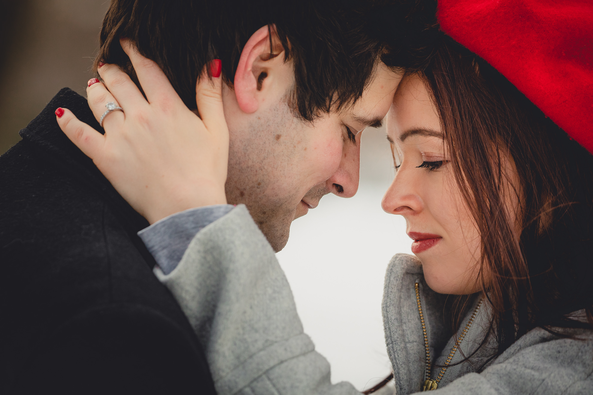 bride and groom touch foreheads on Lincoln Parkway in Delaware Park during their wedding engagement photography session in Buffalo, NY