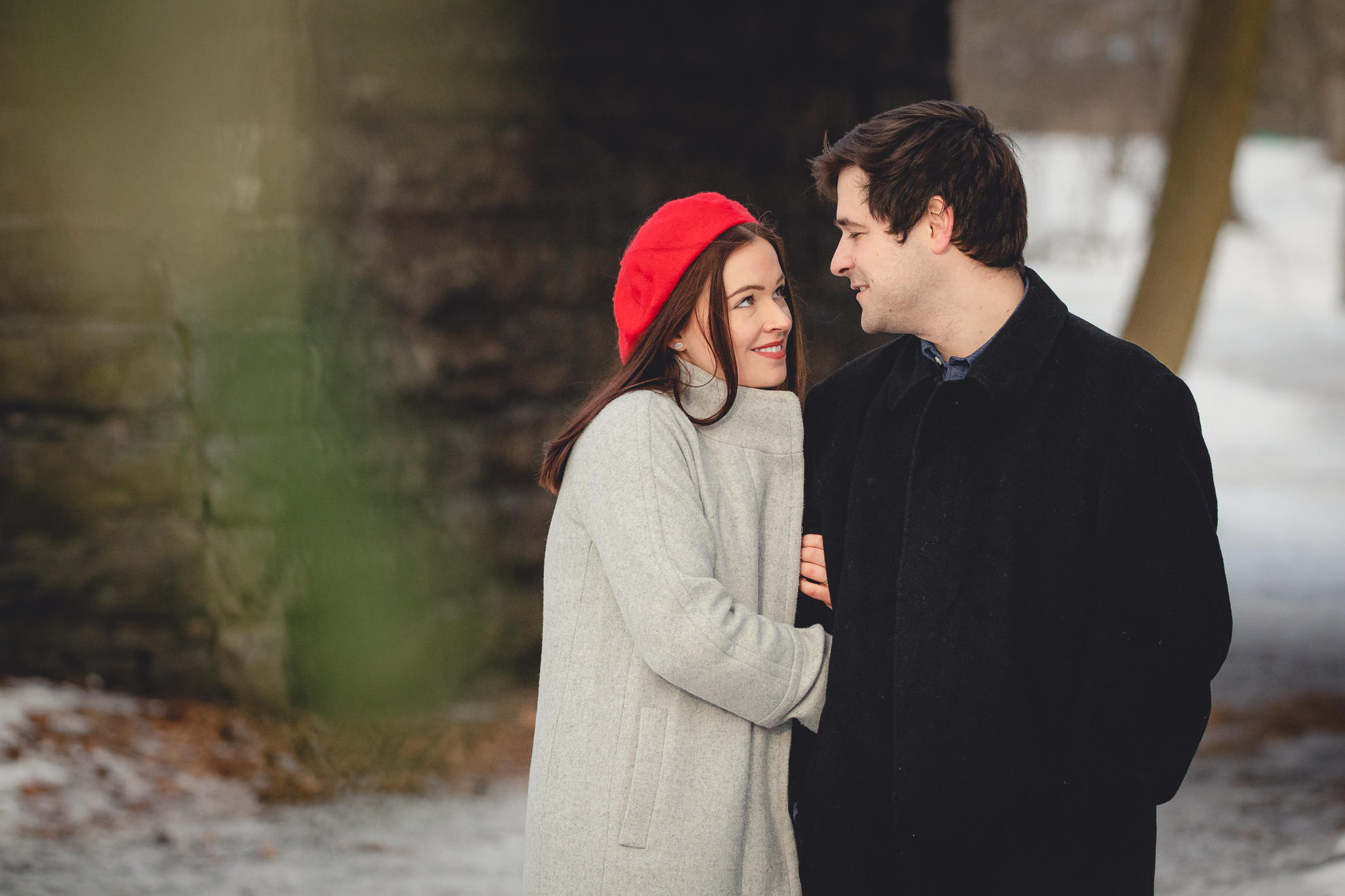 bride and groom smile at one another in front of the Ivy Bridge in Delaware Park during their wedding engagement photography session in Buffalo, NY