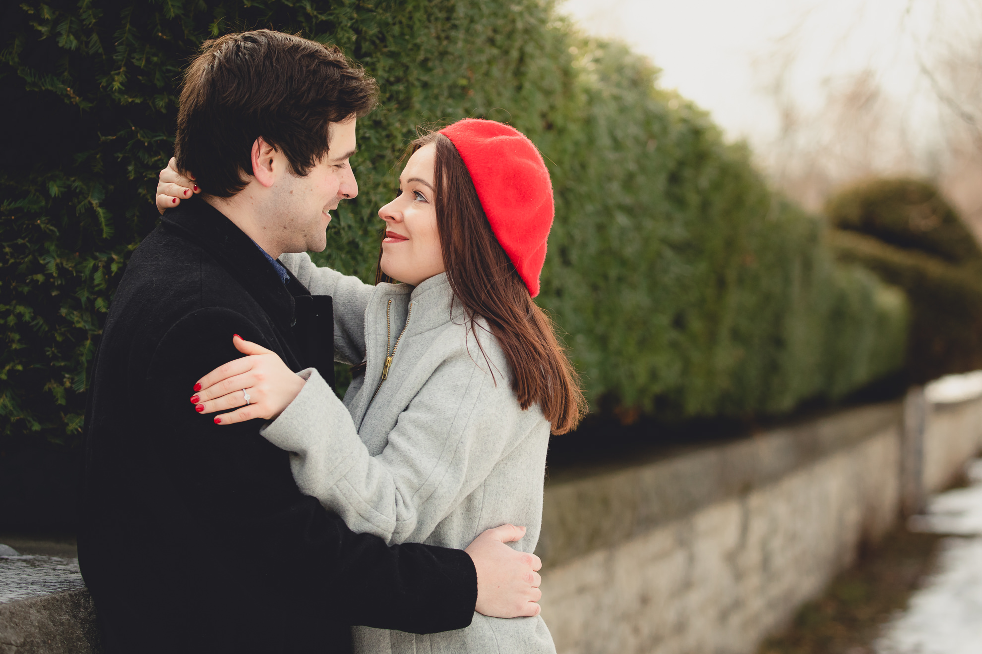 bride and groom smile at one another on Lincoln Parkway in Delaware Park during their wedding engagement photography session in Buffalo, NY