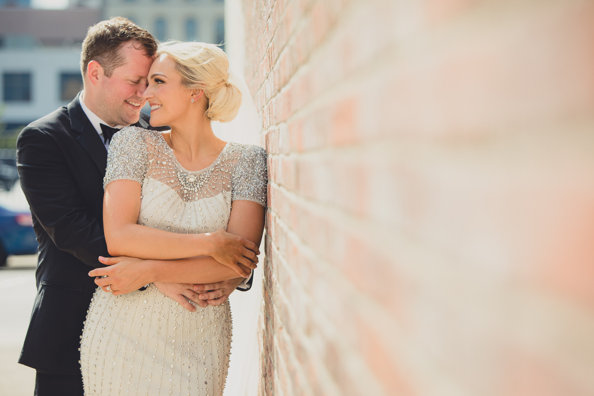 Bride and groom pose for wedding portrait in the theater district of downtown Buffalo.