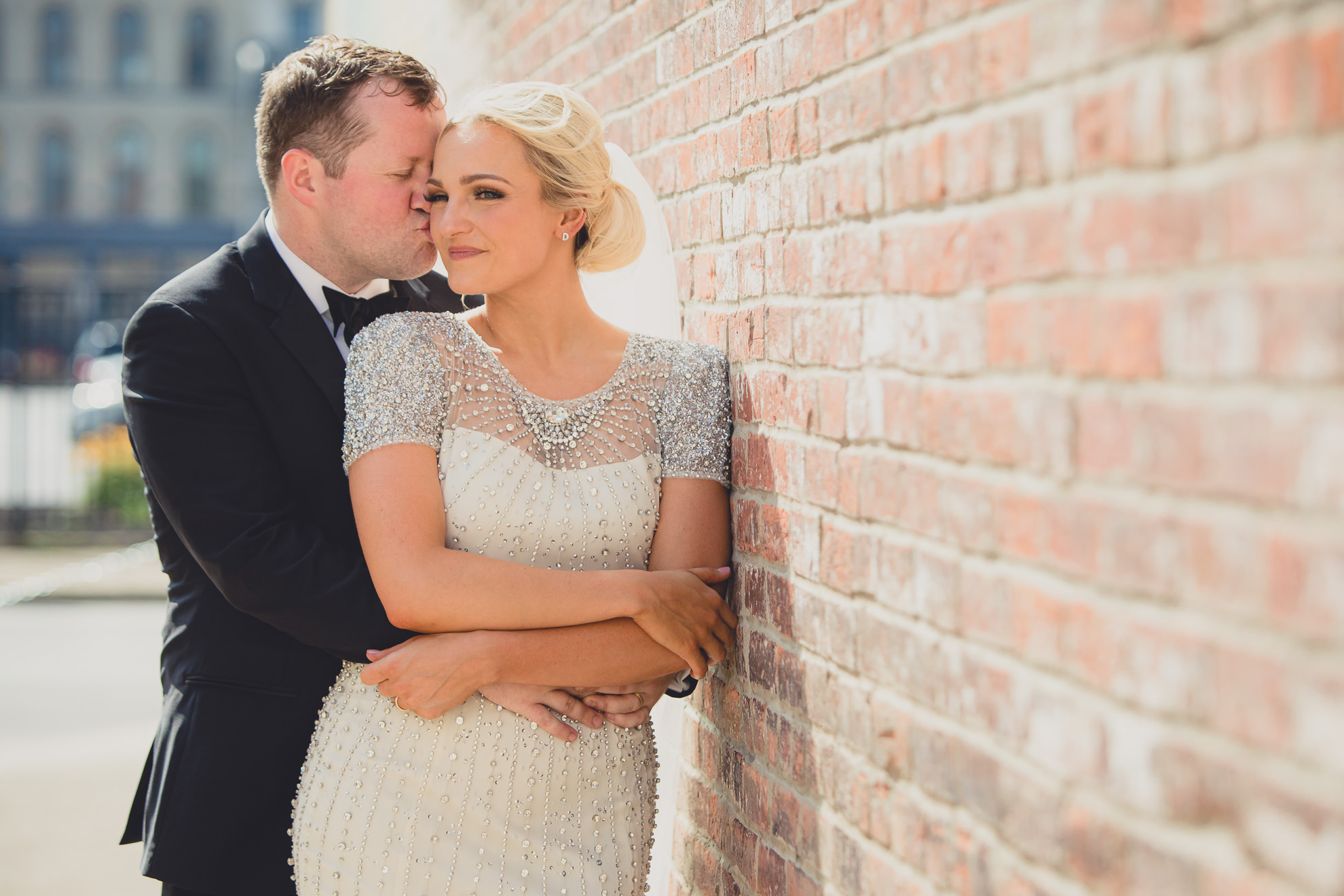 Bride and groom pose for wedding portrait in the theater district of downtown Buffalo.
