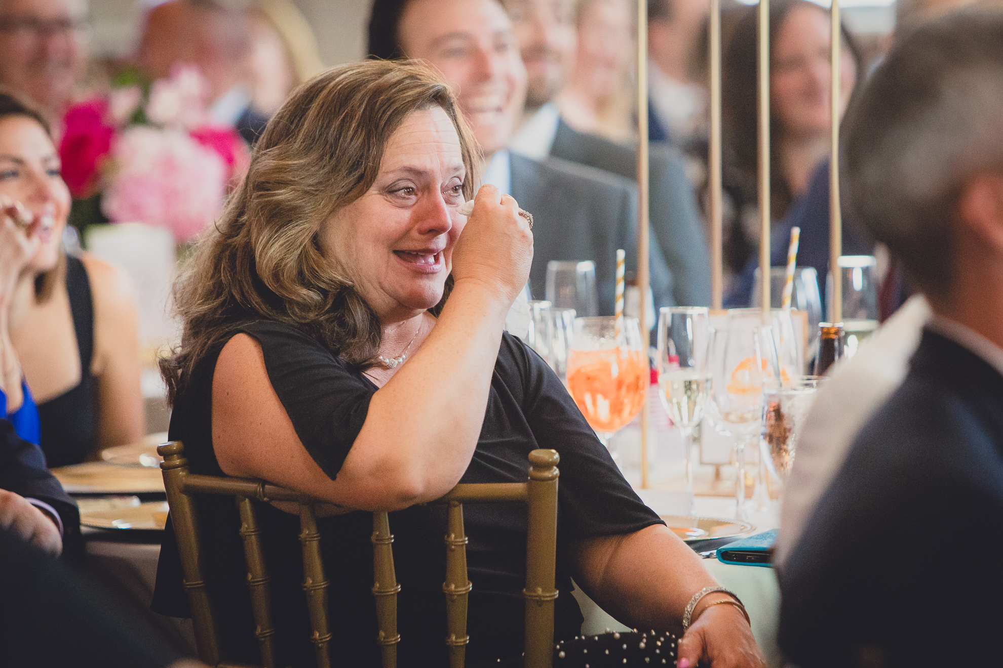 guests smile at bride and groom during speech at Admiral Room Ballroom wedding reception venue in downtown Buffalo, NY
