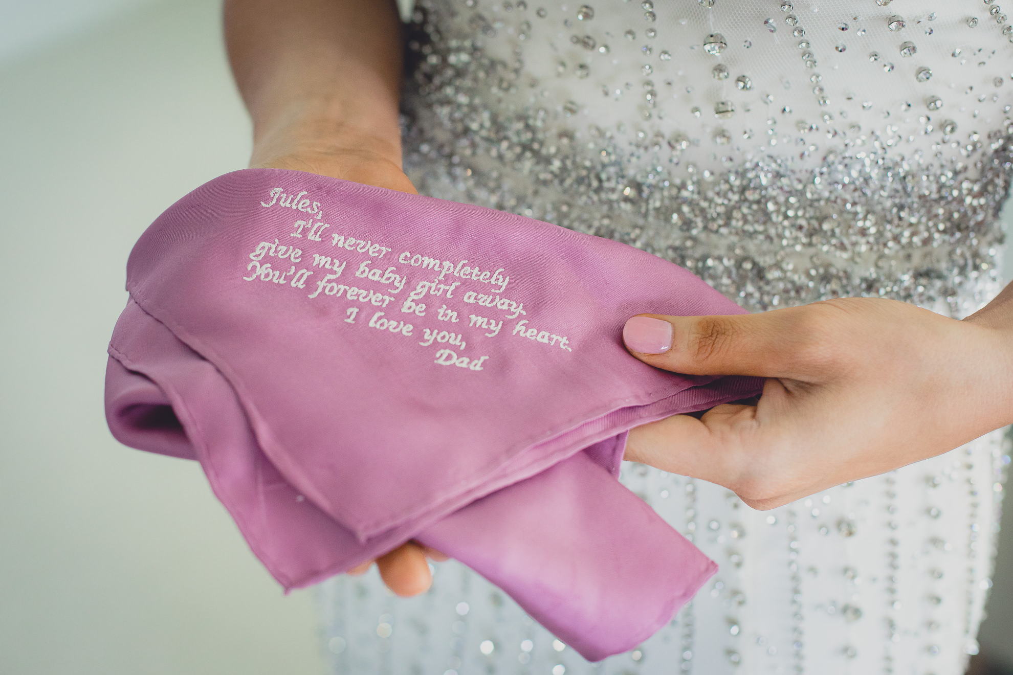 bride with handkerchief gifted by her dad before wedding in Lewiston, NY