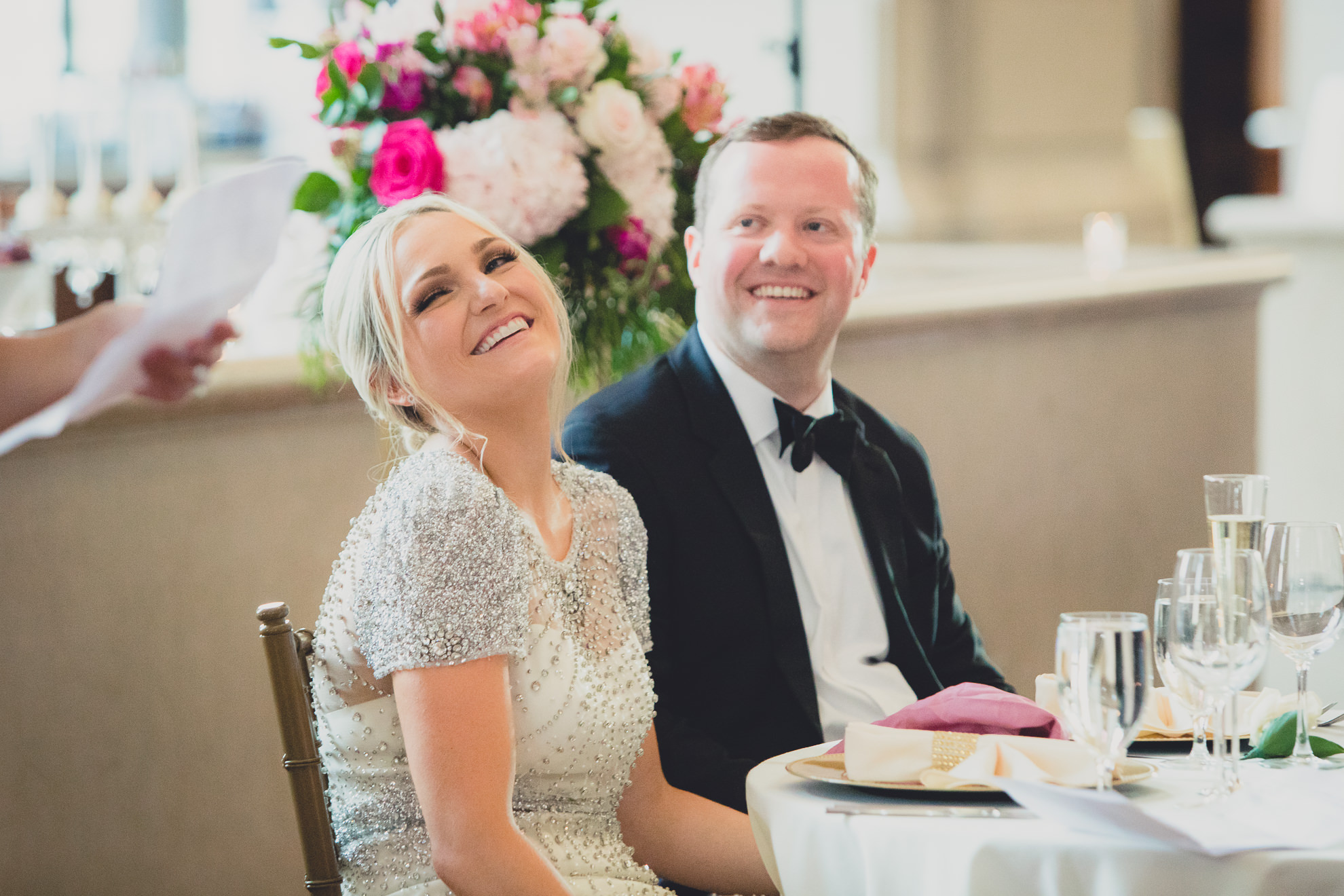 bride and groom laugh during speech at Admiral Room Ballroom wedding reception venue in downtown Buffalo, NY