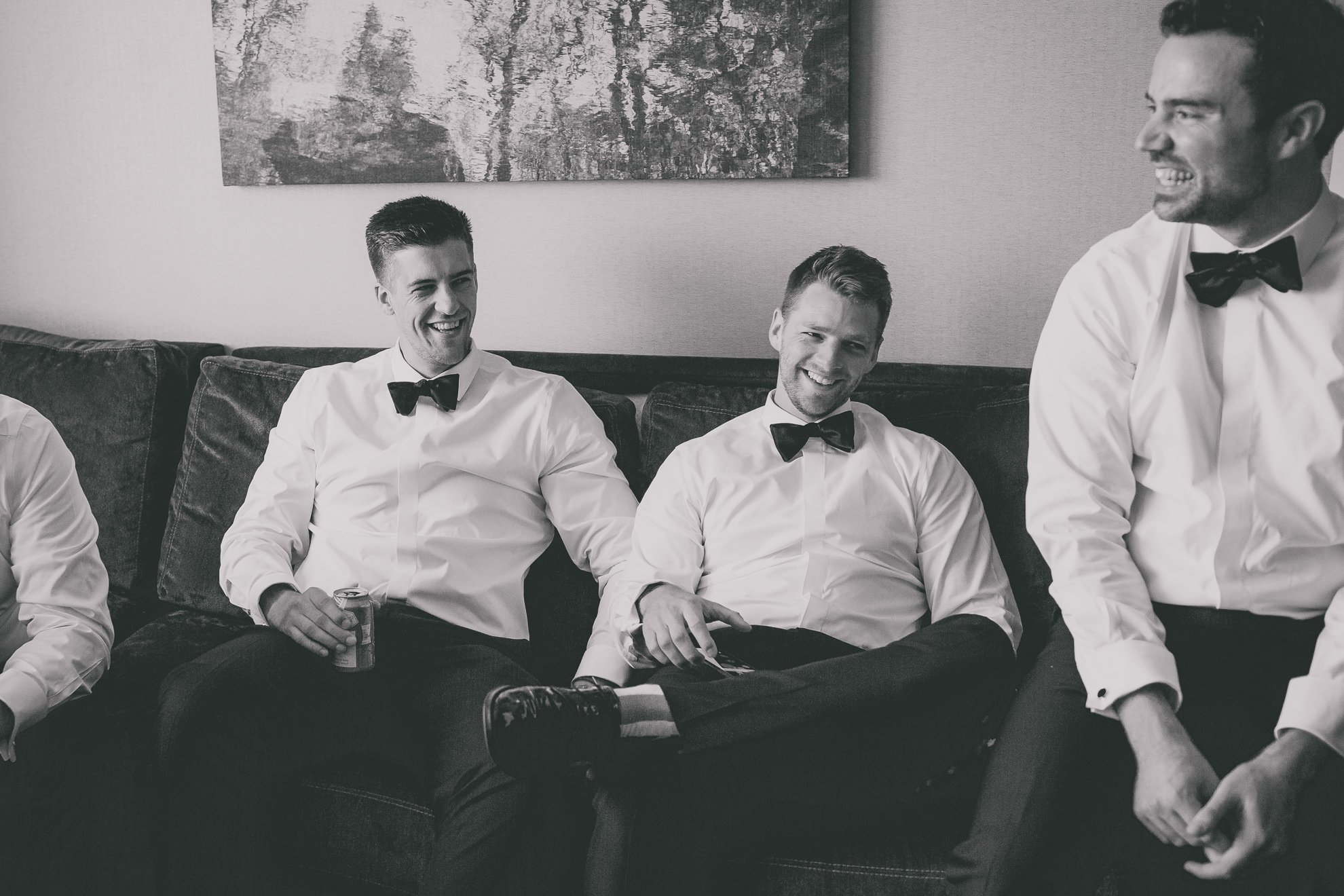 groomsman relax while getting ready for wedding ceremony at the Westin Hotel in Buffalo, NY