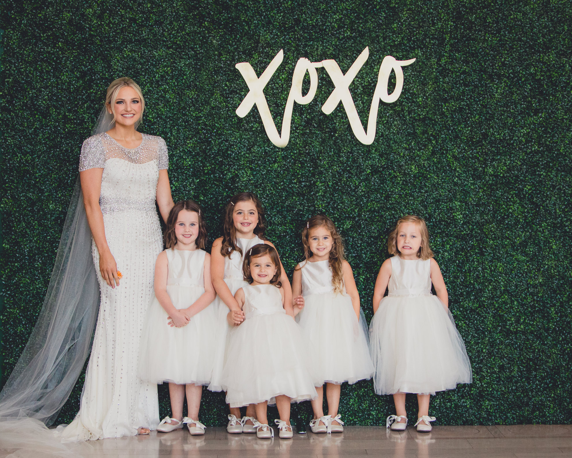bride poses for portrait with flower girls at the Admiral Room wedding venue in Buffalo, NY
