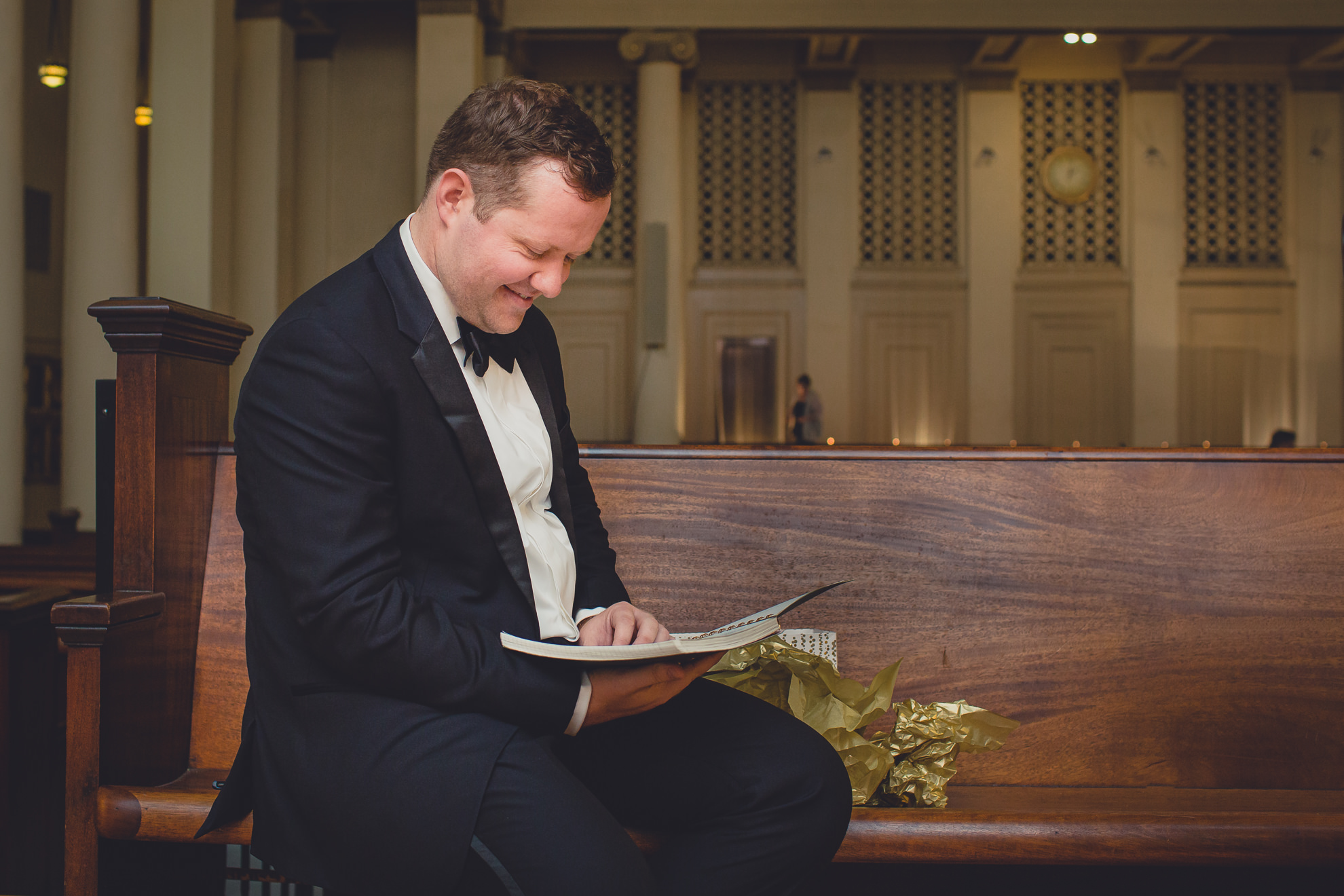 groom reads letters from bride before wedding ceremony at Karpeles Manuscript Library in Buffalo, NY