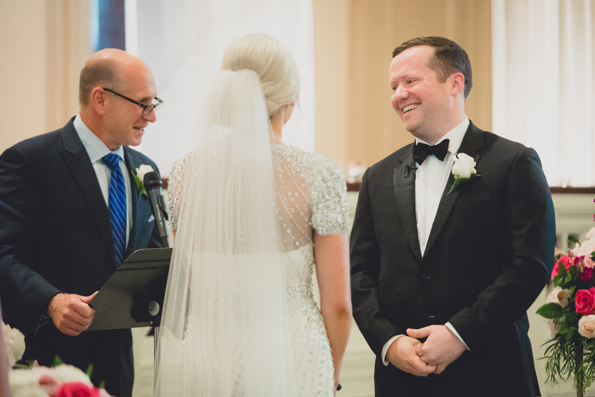 groom laughs during wedding ceremony at Karpeles Manuscript Library in Buffalo, NY