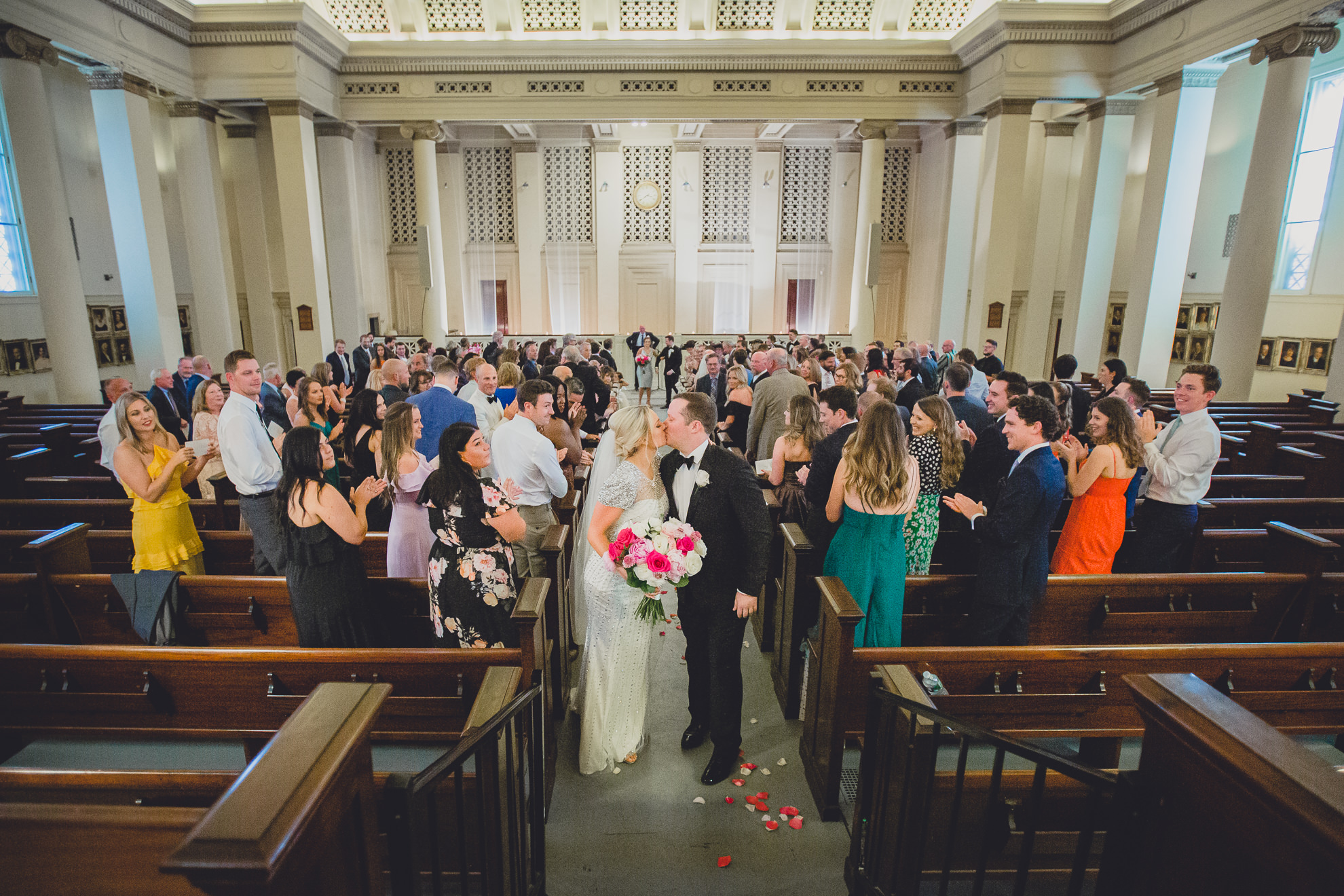 bride and groom kiss during wedding ceremony at Karpeles Manuscript Library in Buffalo, NY