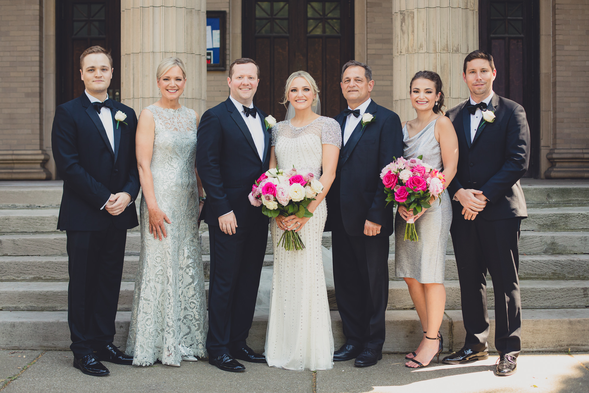 family poses for portrait on front steps of Karpeles Manuscript library after wedding ceremony in Buffalo, NY