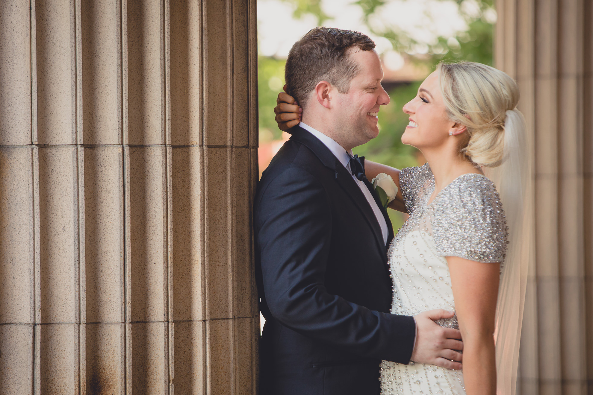 Bride and groom pose for wedding portrait on front steps of Karpeles Manuscript library in Buffalo, NY