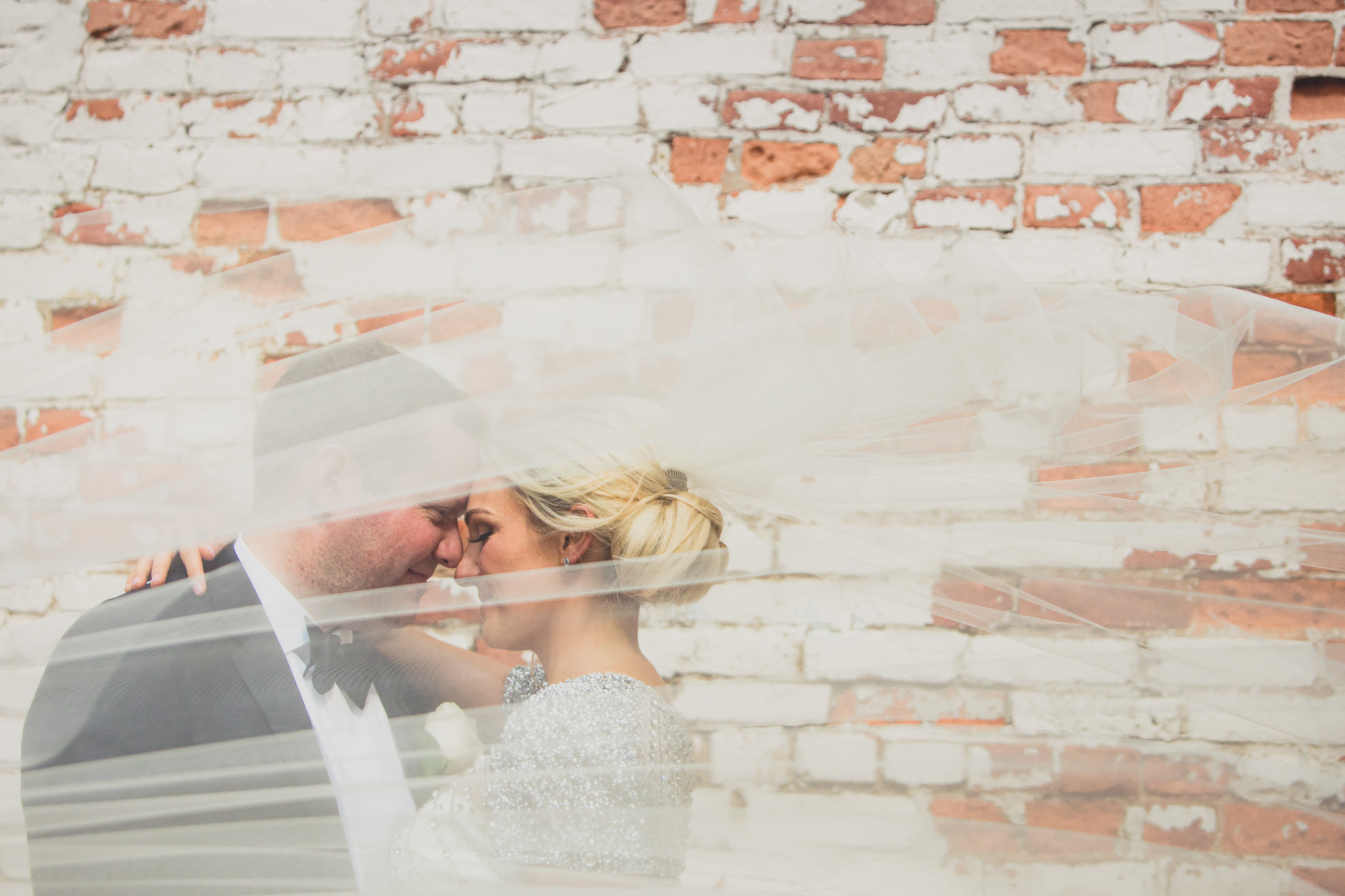 Bride and groom pose for wedding portrait in the theater district of downtown Buffalo.