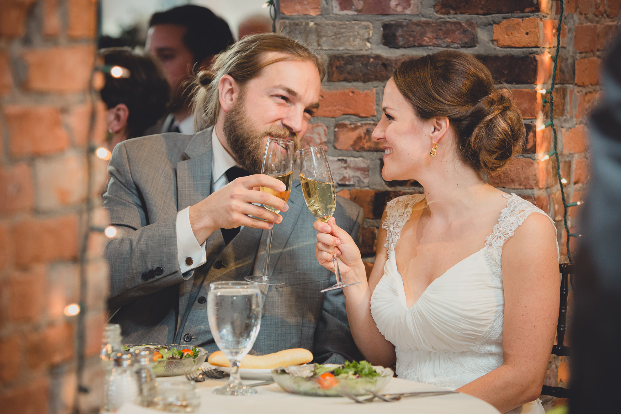 bride and groom toast during speeches at wedding reception venue Pearl at the Webb in Buffalo, NY
