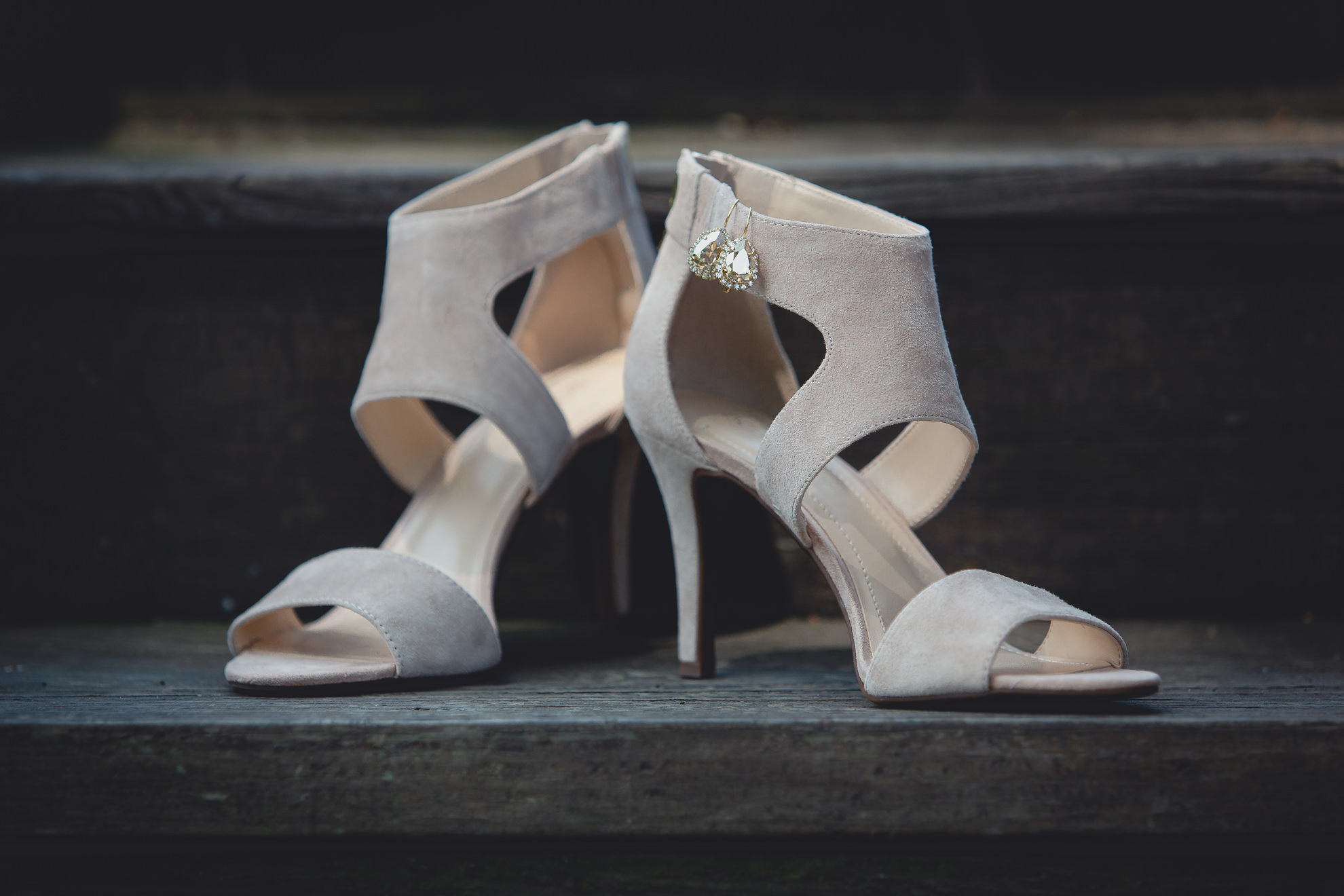 brides shoes and earrings sit on steps before wedding ceremony in Buffalo, NY