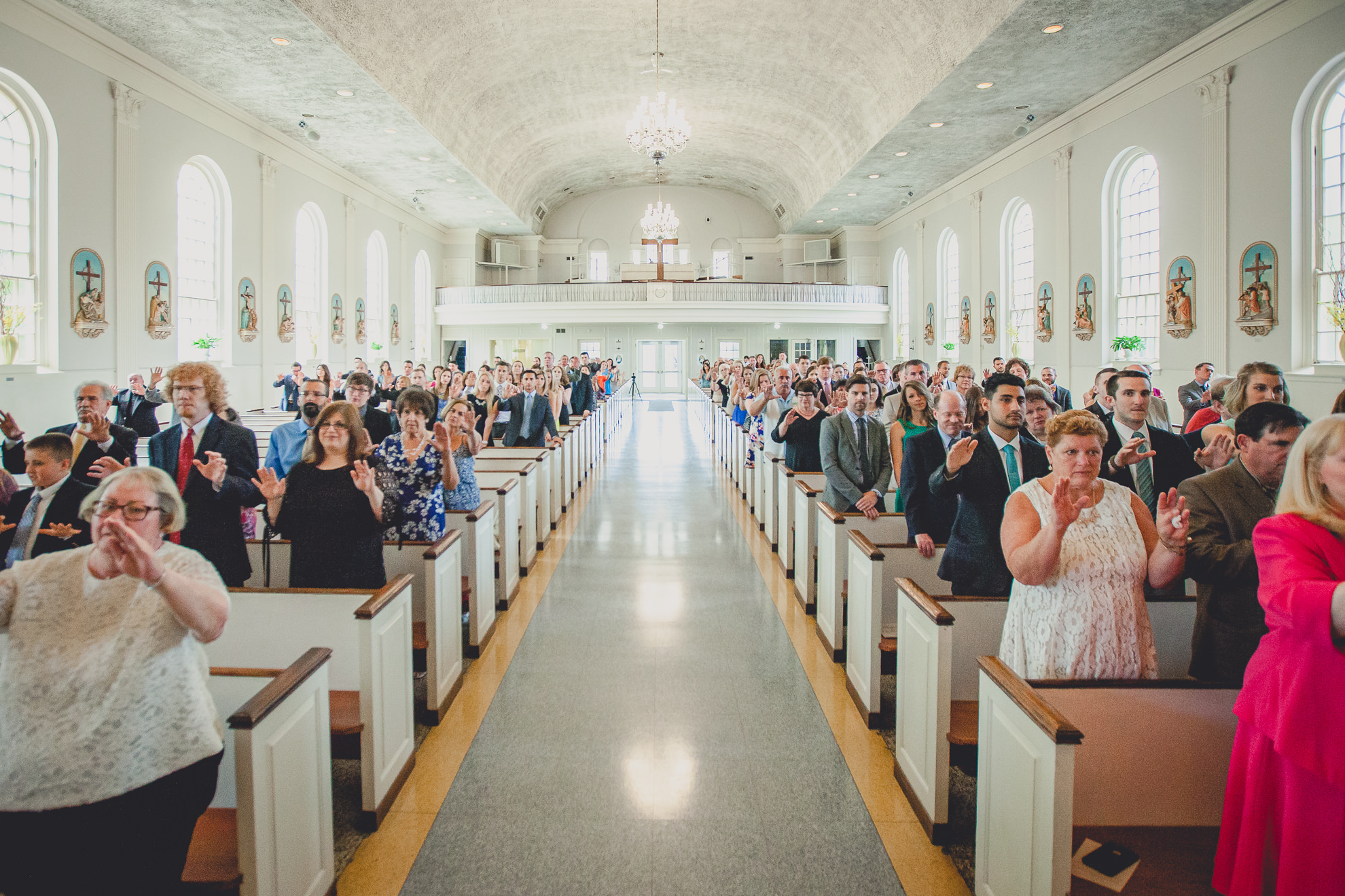 guests pray during wedding ceremony at St. John the Baptist church in Kenmore, NY