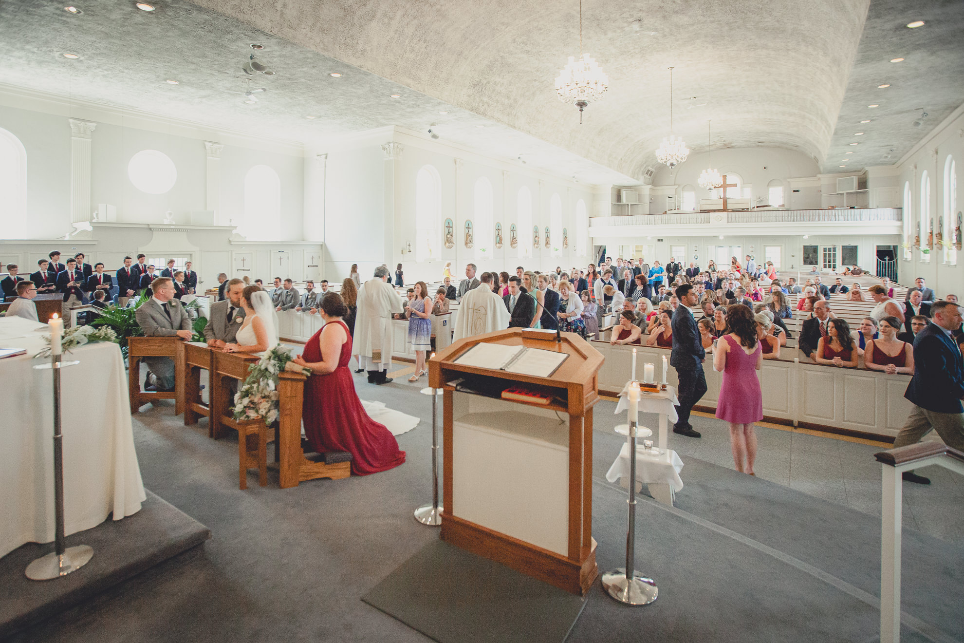 guests receive communion during wedding ceremony at St. John the Baptist church in Kenmore, NY