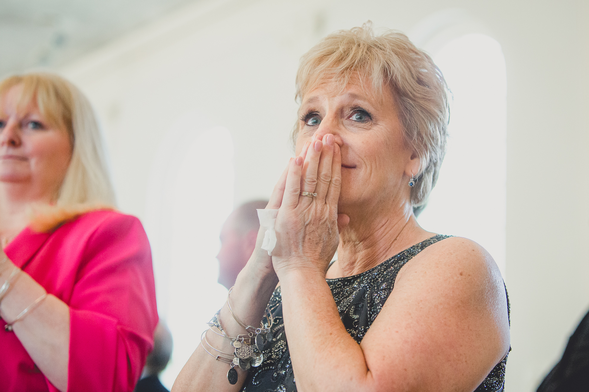 mother of bride cries during wedding ceremony at St. John the Baptist church in Kenmore, NY