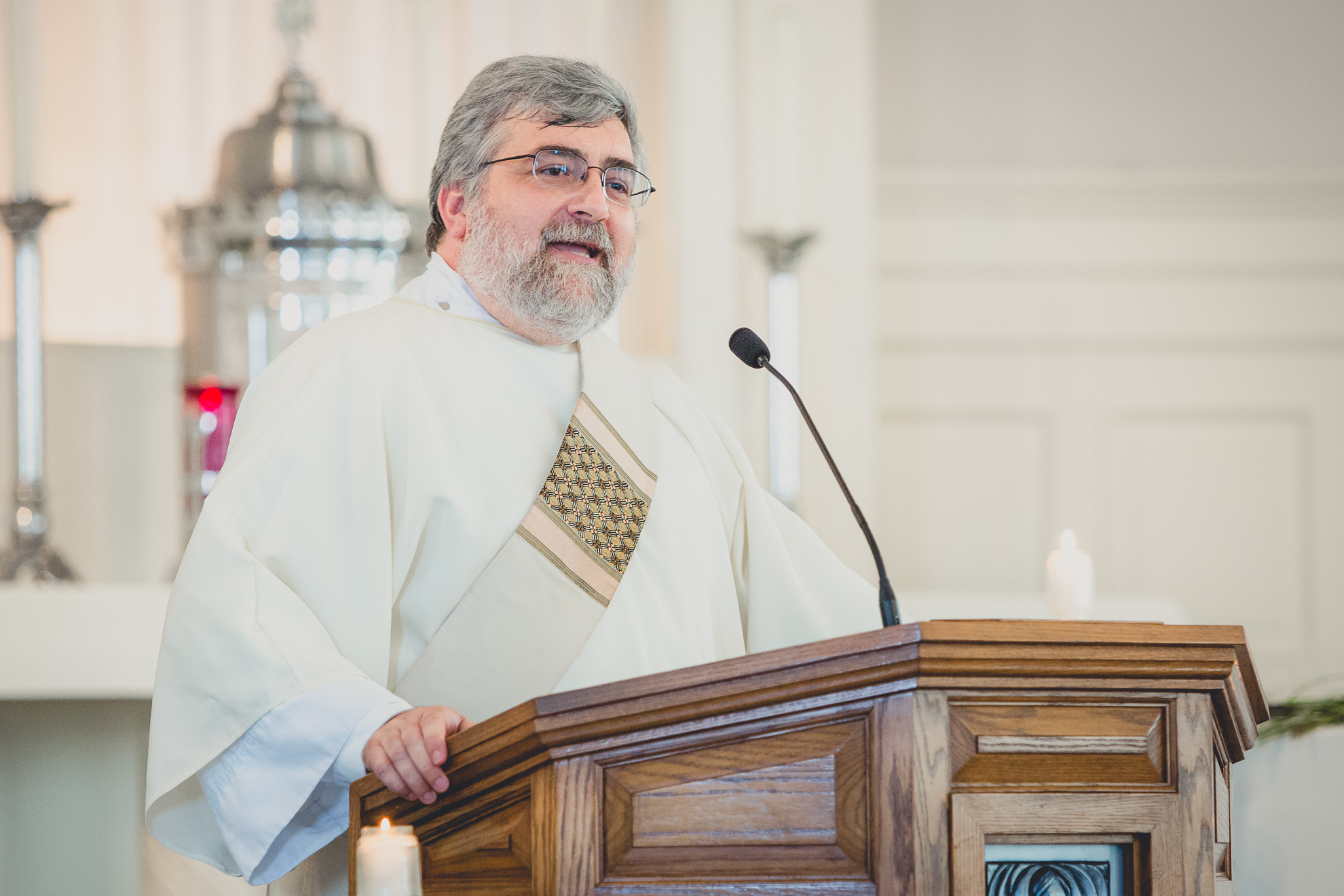 priest delivers sermon during wedding ceremony at St. John the Baptist church in Kenmore, NY