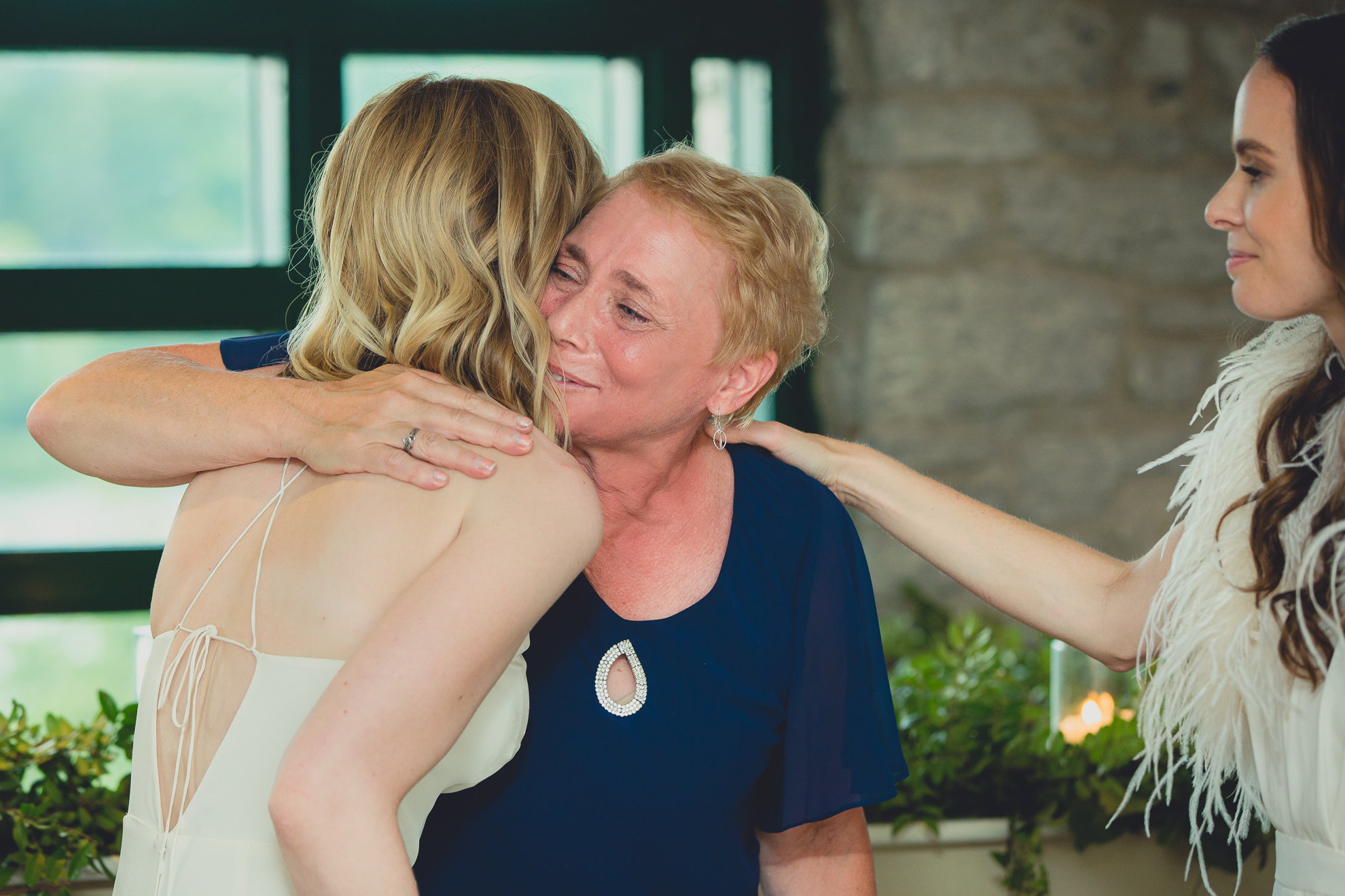 bride hugs mom after speech during wedding at Marcy Casino in Delaware Park in Buffalo, NY