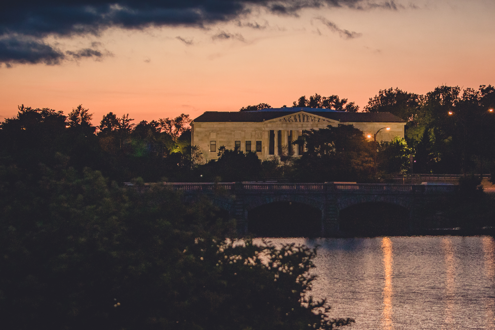 sunset over Hoyt Lake and science museum during wedding at Marcy Casino in Delaware Park in Buffalo, NY