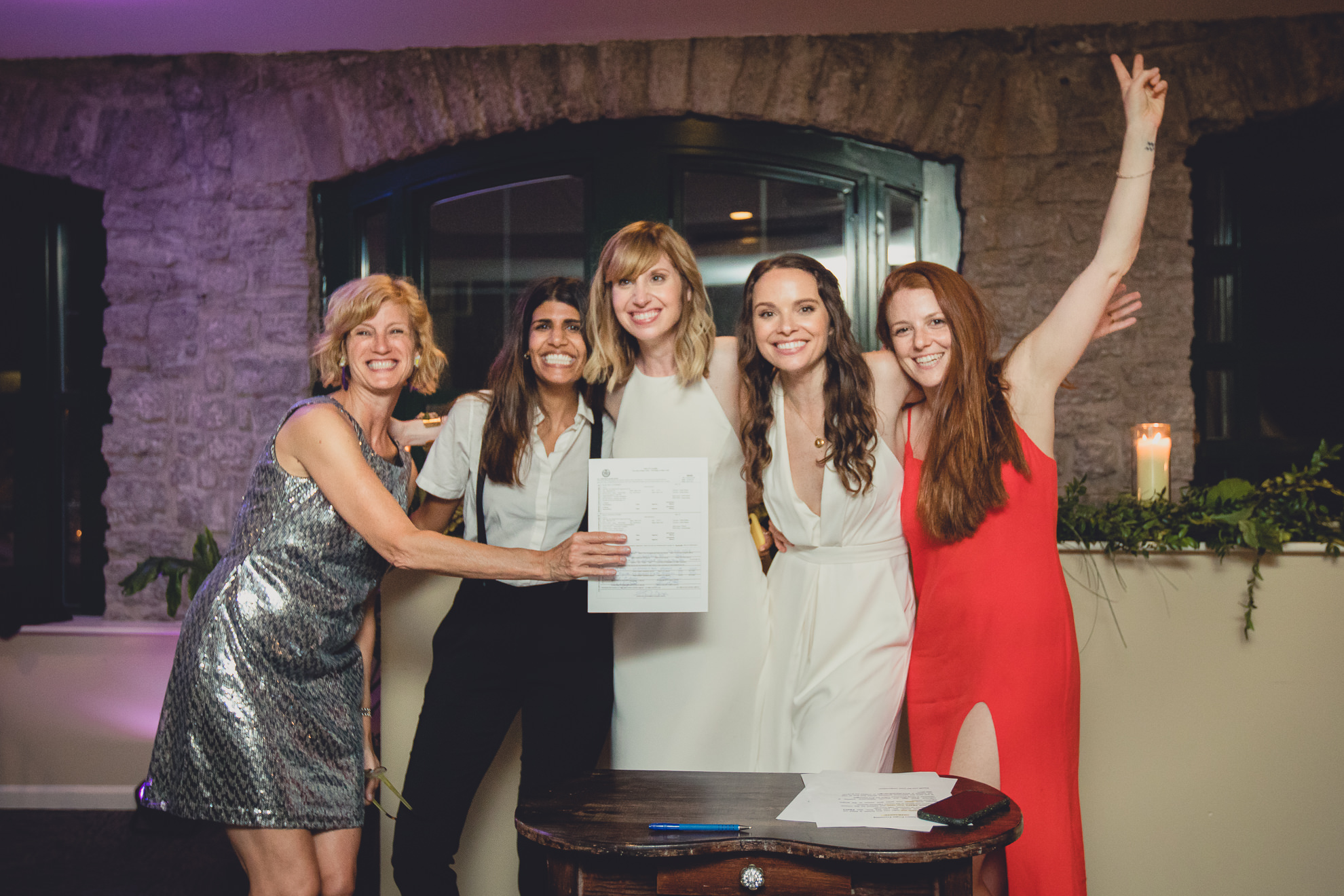 brides and witnesses sign marriage license during wedding at Marcy Casino in Delaware Park in Buffalo, NY
