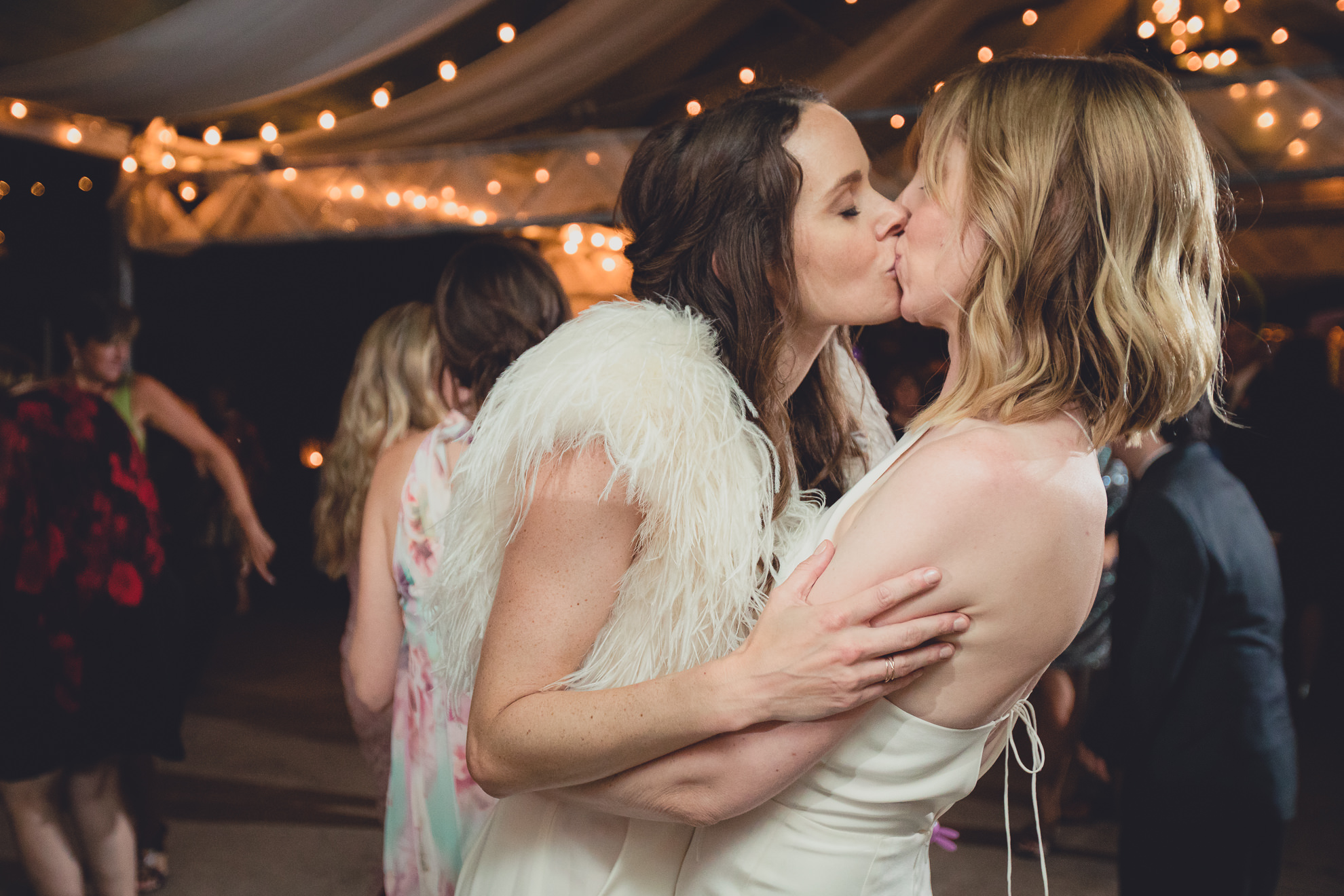 brides kiss during wedding at Marcy Casino in Delaware Park in Buffalo, NY