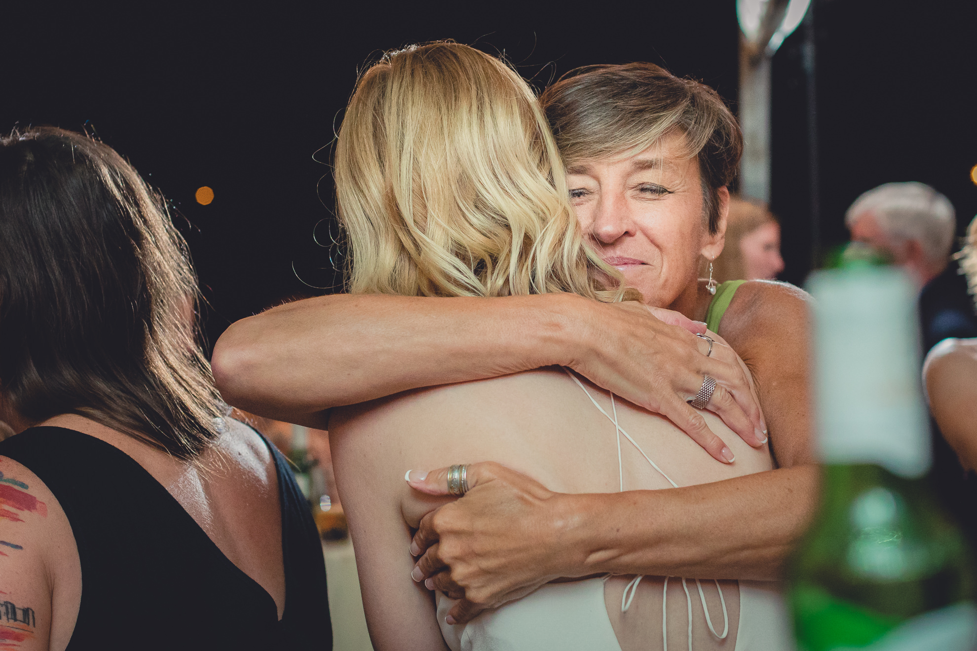 guests hug during wedding at Marcy Casino in Delaware Park in Buffalo, NY