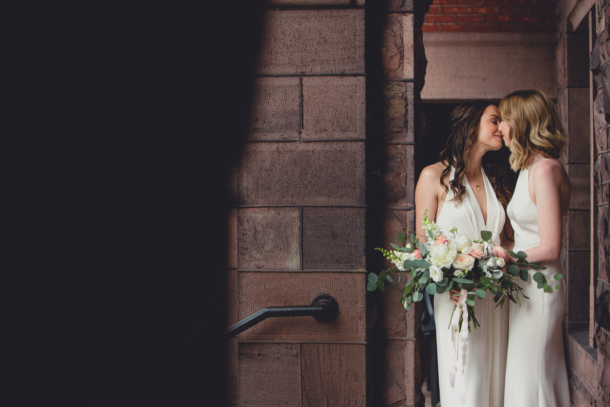 brides kiss during portrait session before wedding at Hotel Henry in Buffalo, NY