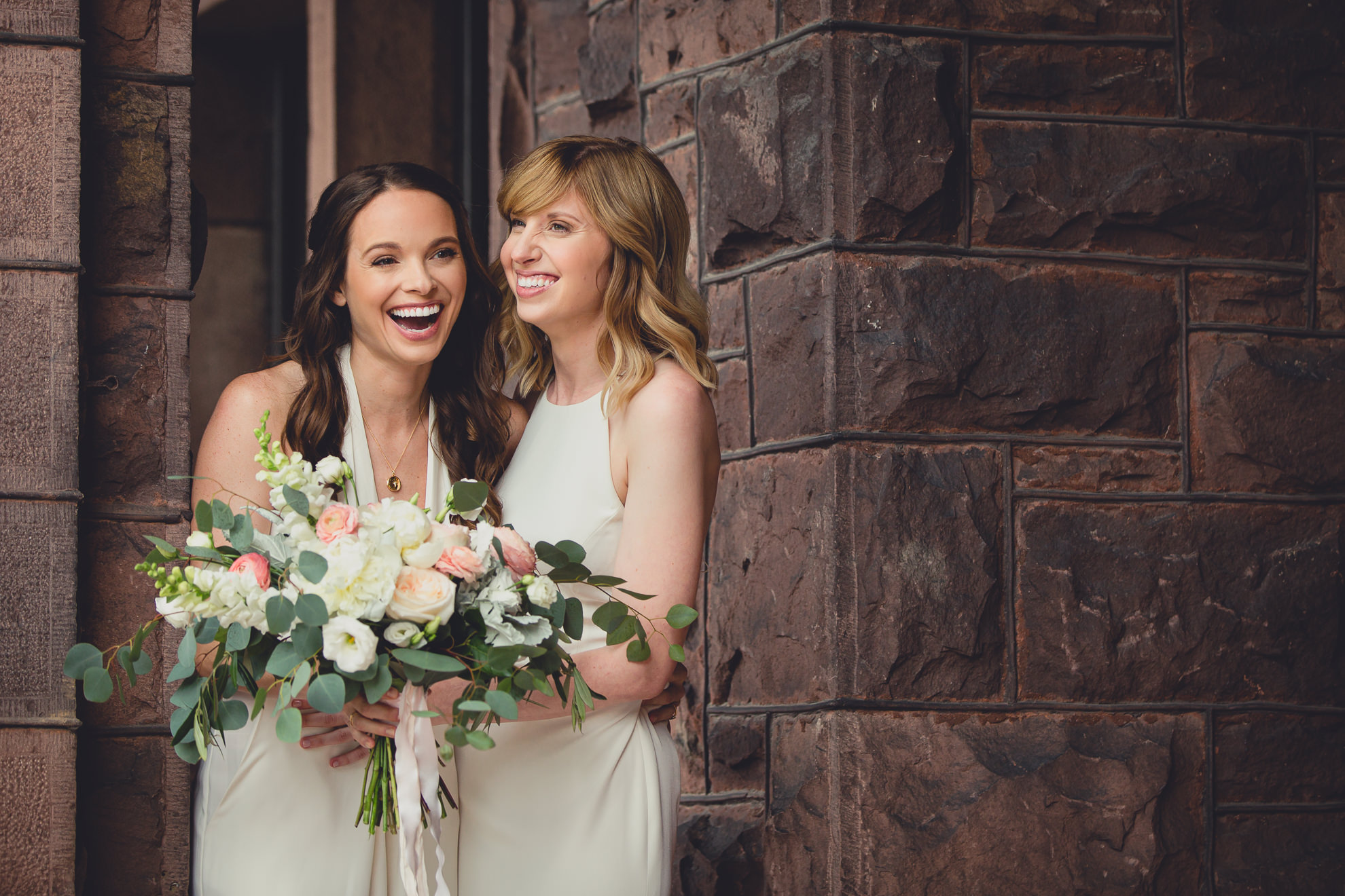 brides laugh during portrait session before wedding at Hotel Henry in Buffalo, NY