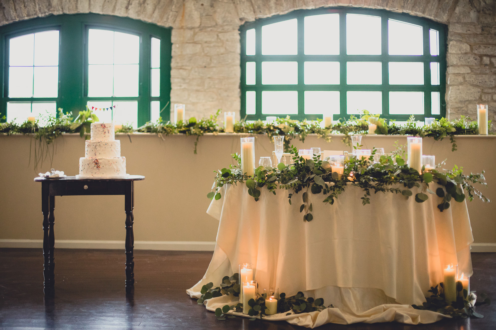 wedding decor featuring greens and rainbow cake during wedding at Marcy Casino in Delaware Park in Buffalo, NY