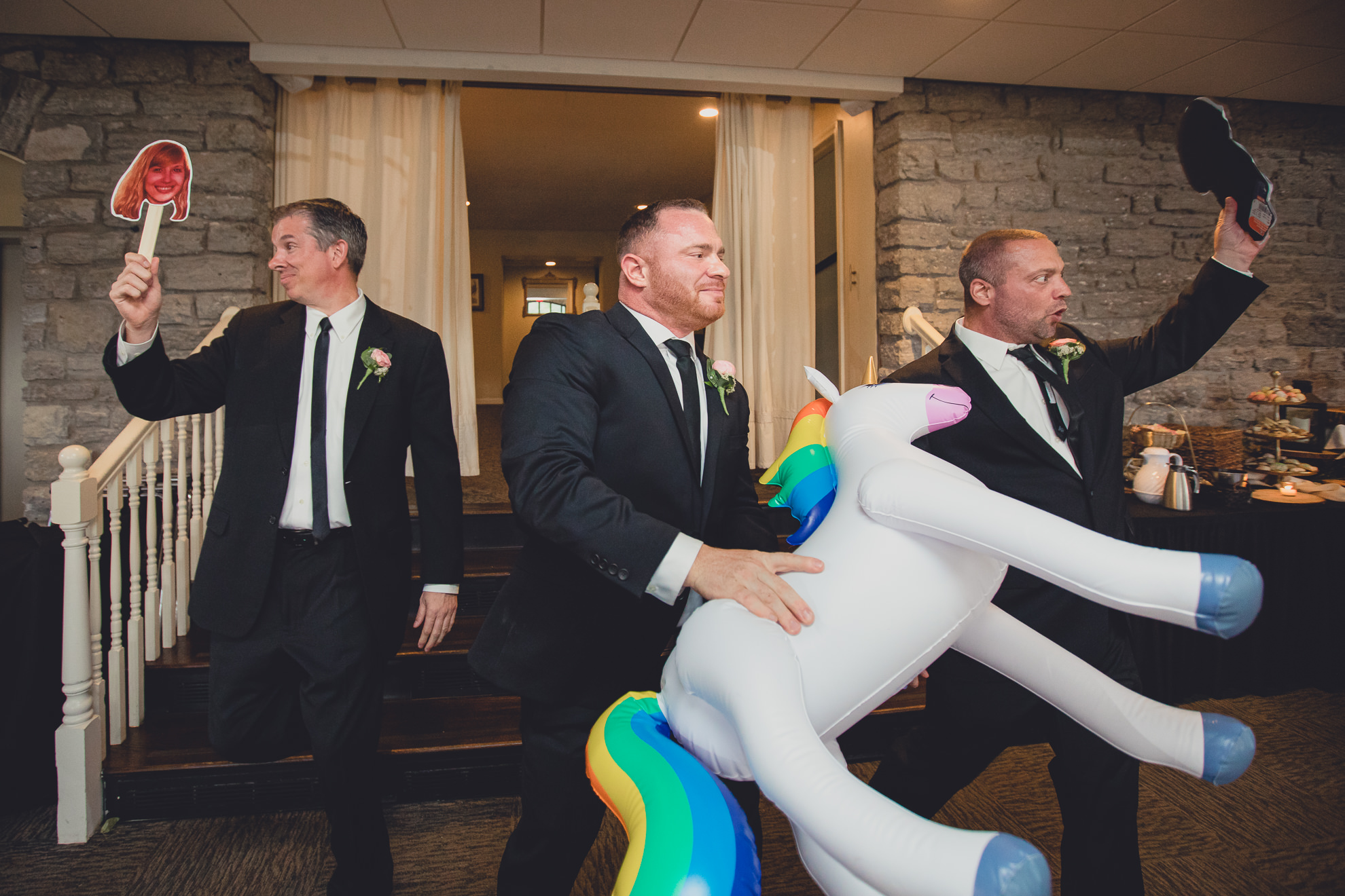 wedding party carries rainbow unicorn during introductions during wedding at Marcy Casino in Delaware Park in Buffalo, NY