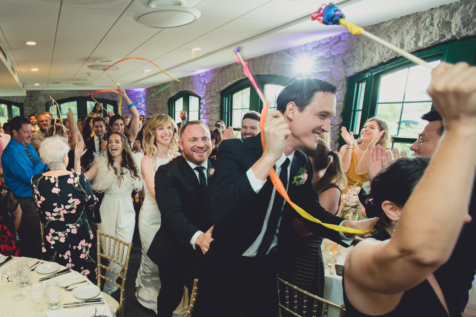 wedding party dances locomotion style during introductions during wedding at Marcy Casino in Delaware Park in Buffalo, NY