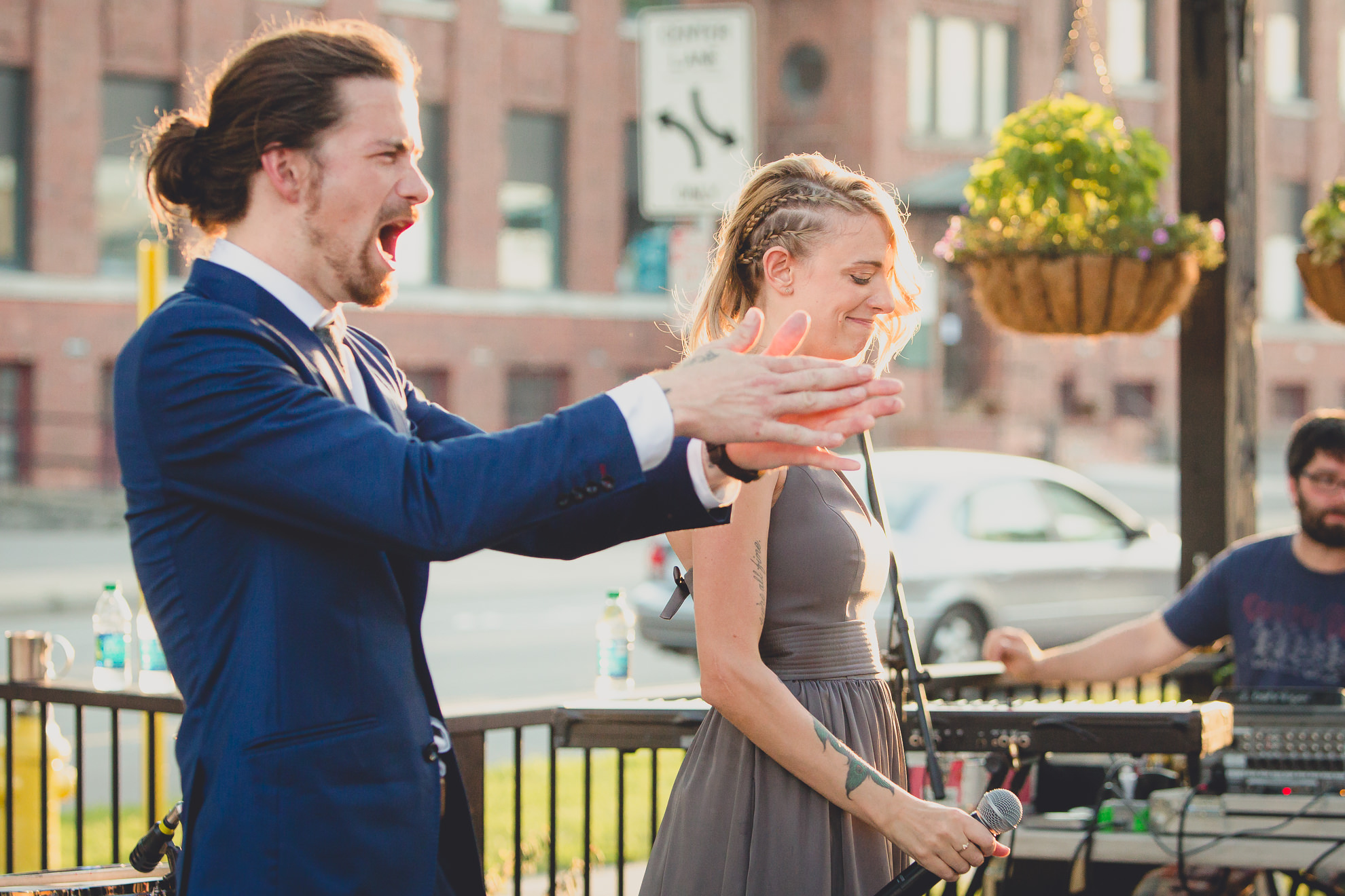 best man and maid of honor deliver speeches during outdoor wedding reception at the Revelry in Rochester, NY 