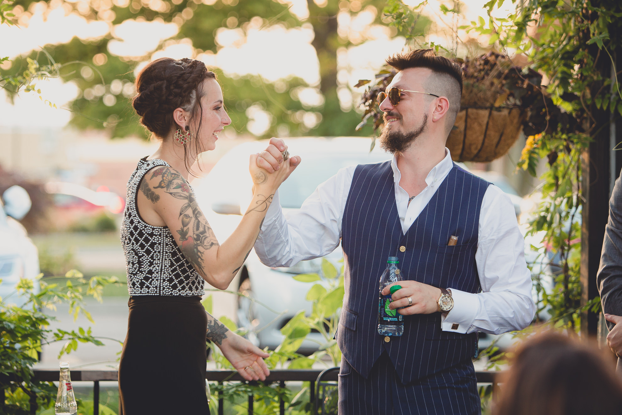 bride and groom react to speeches during outdoor wedding reception at the Revelry in Rochester, NY 