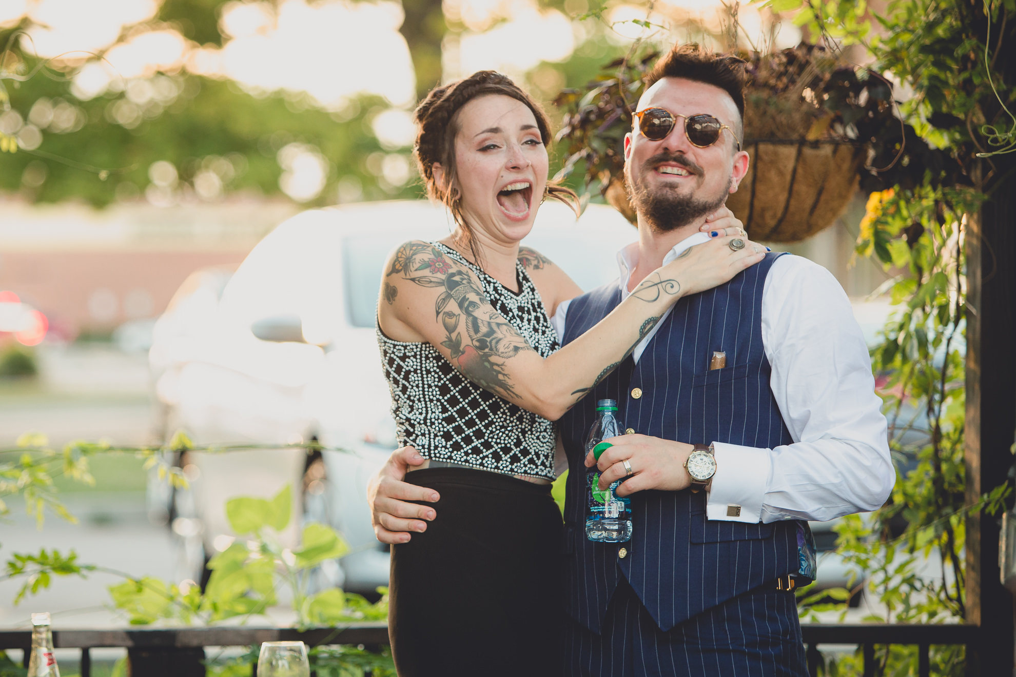 bride and groom react to speeches during outdoor wedding reception at the Revelry in Rochester, NY 