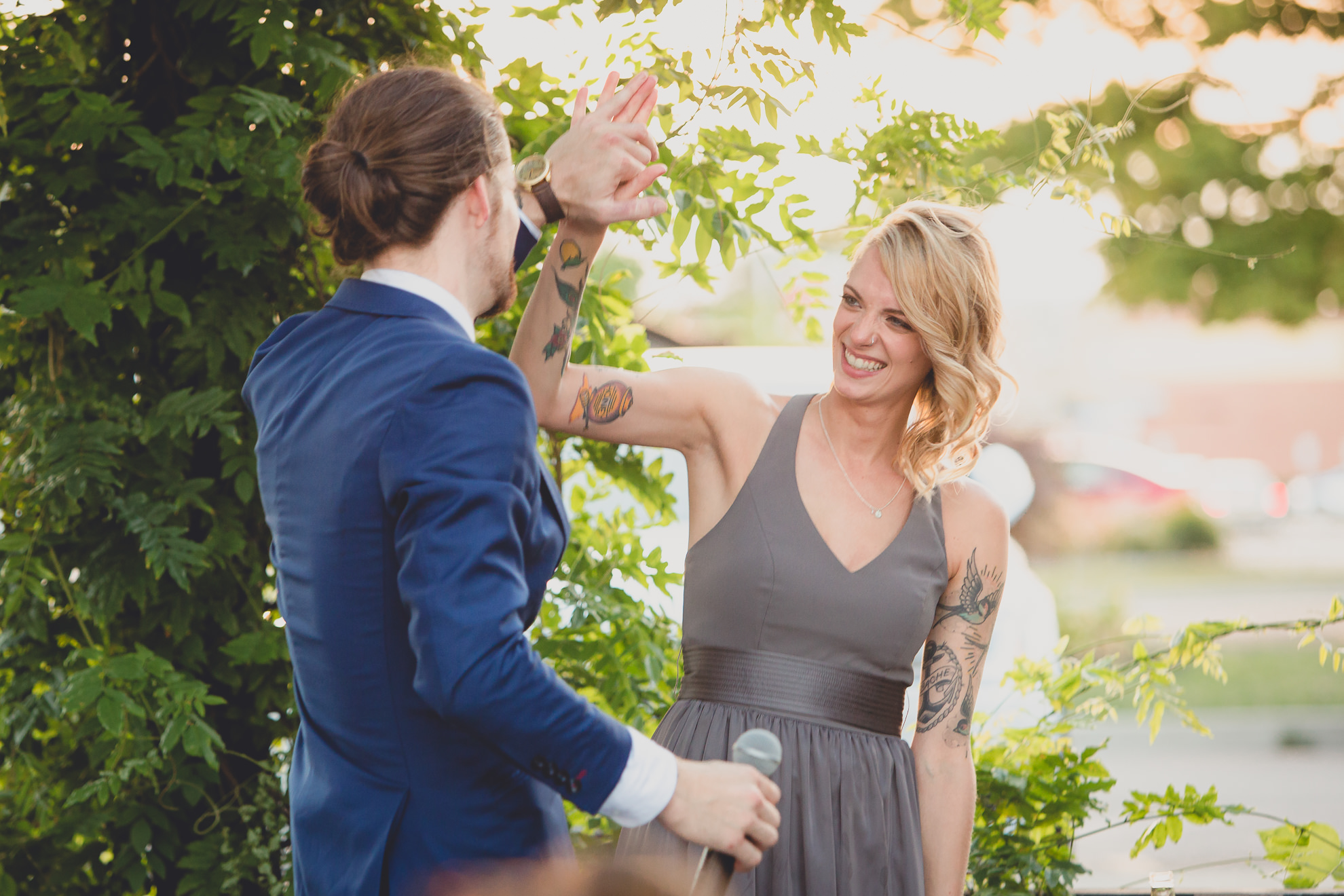 best man and maid of honor deliver speeches during outdoor wedding reception at the Revelry in Rochester, NY 