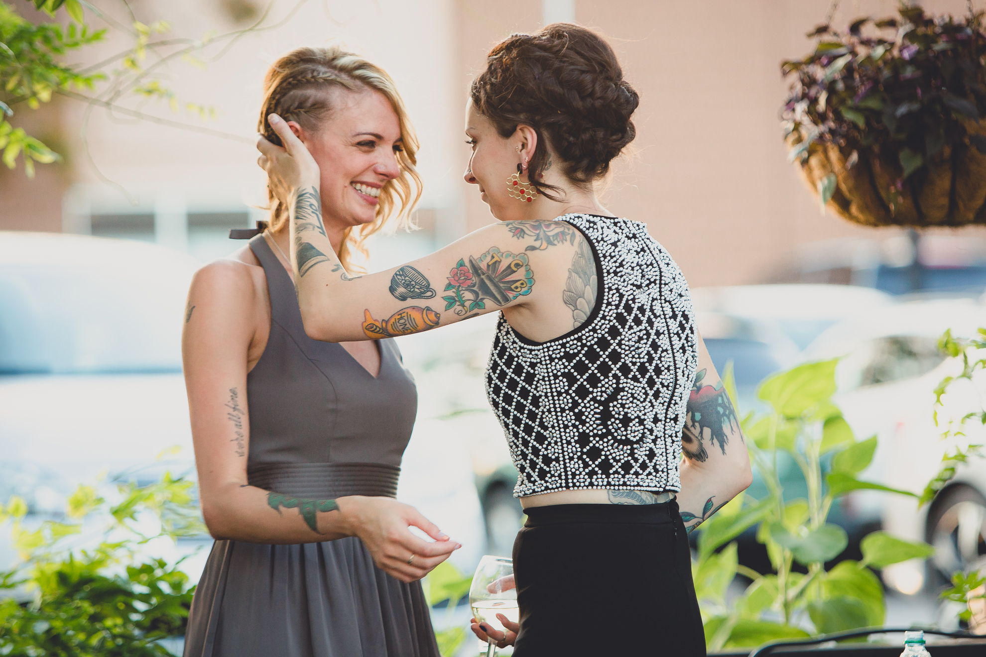 bride hugs maid of honor during outdoor wedding reception at the Revelry in Rochester, NY 