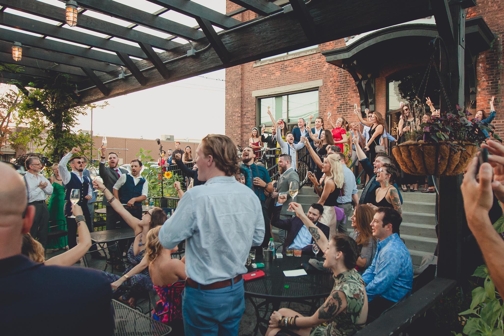 guests toast bride and groom during outdoor wedding reception at the Revelry in Rochester, NY 